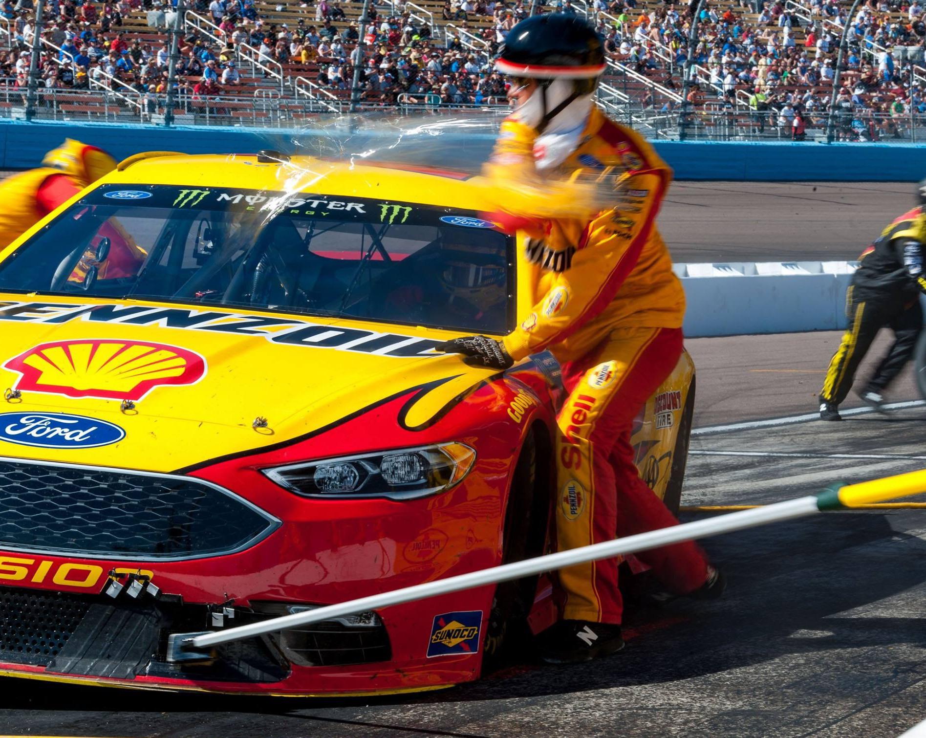 ITAP of a NASCAR crew member attacking a windshield tearoff