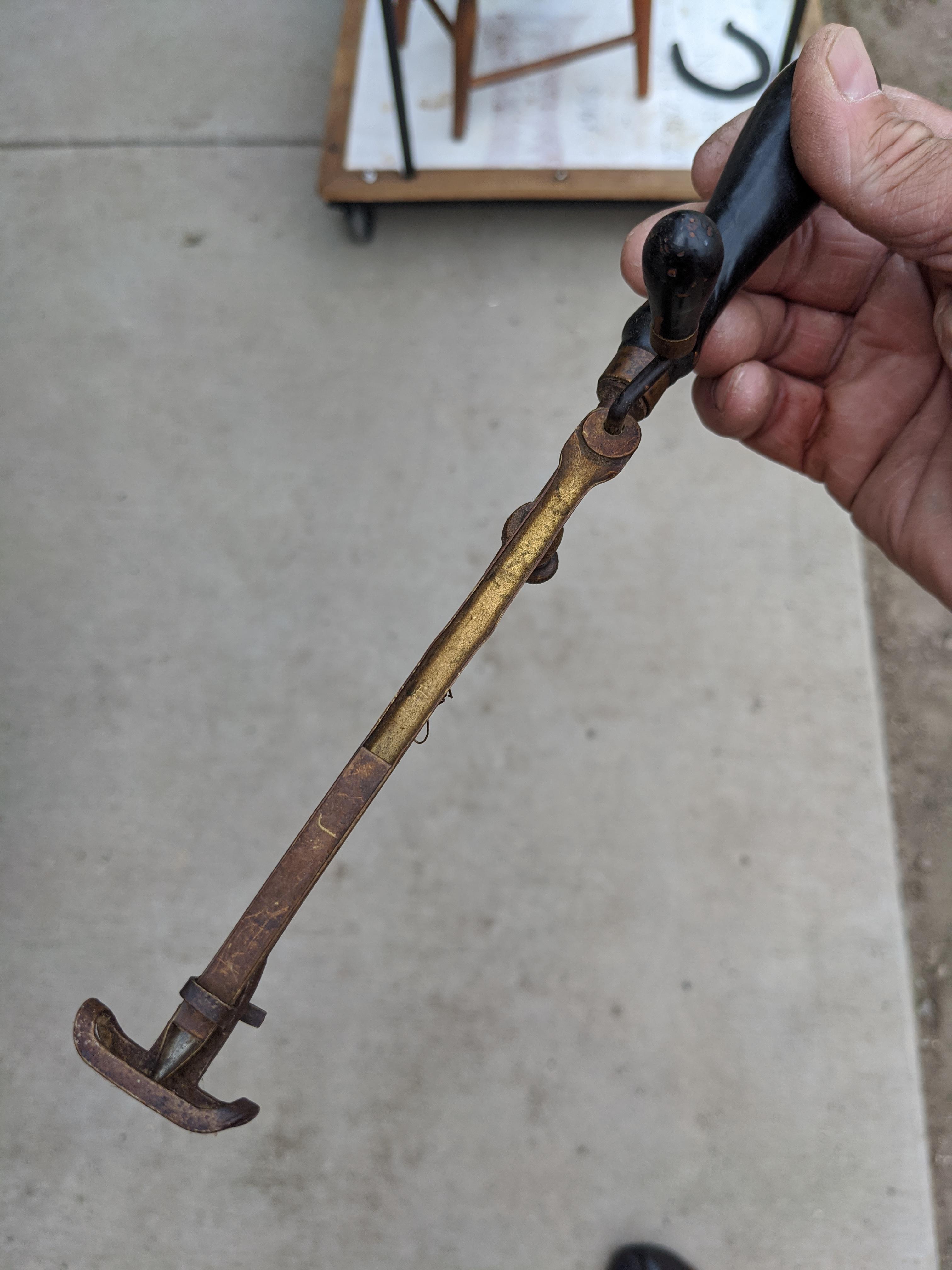 12" long brass and wood tool with small hand crank appears capable of