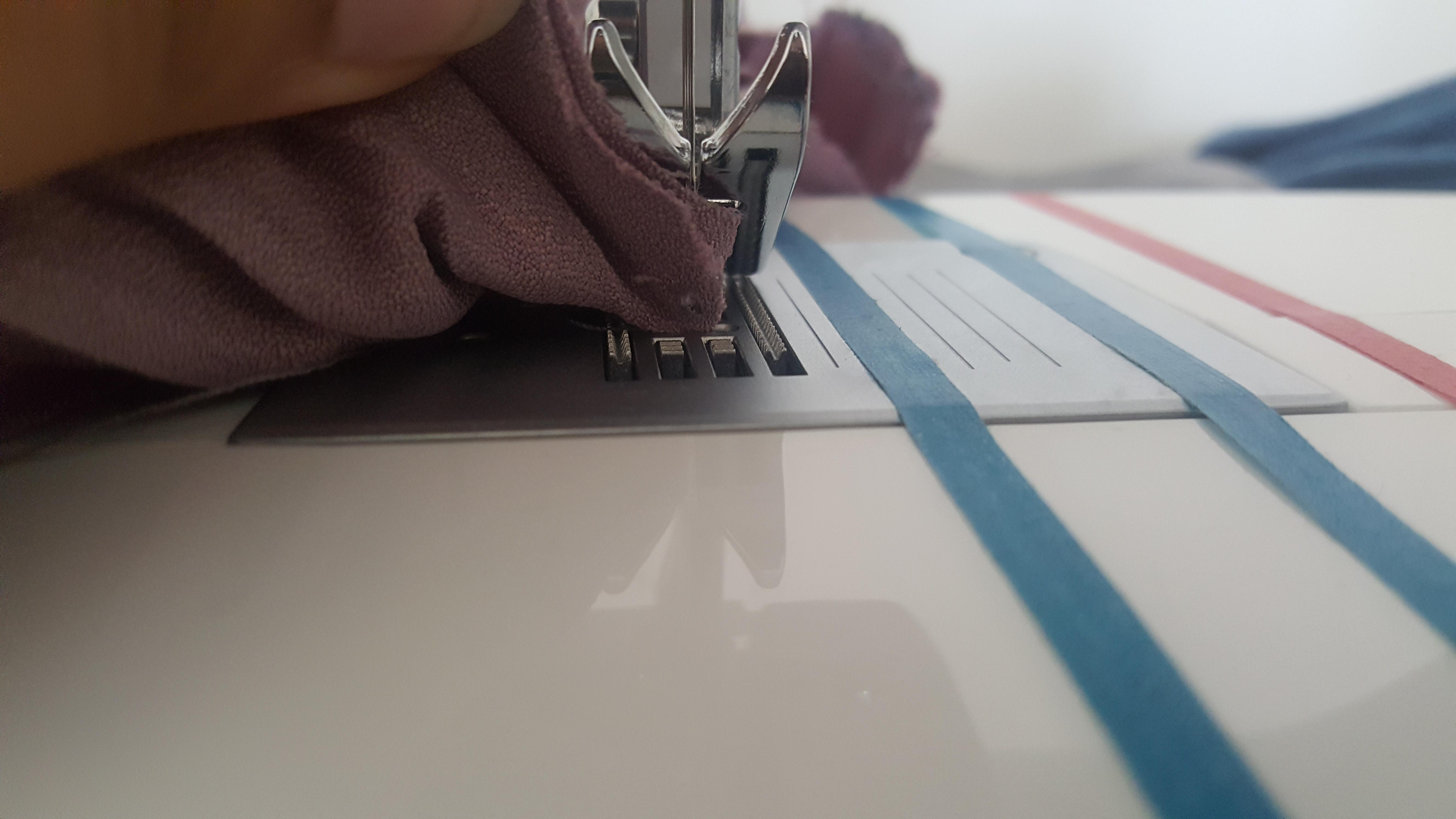 Fabric keeps gerting stuck between the feedjng dogs whenever I