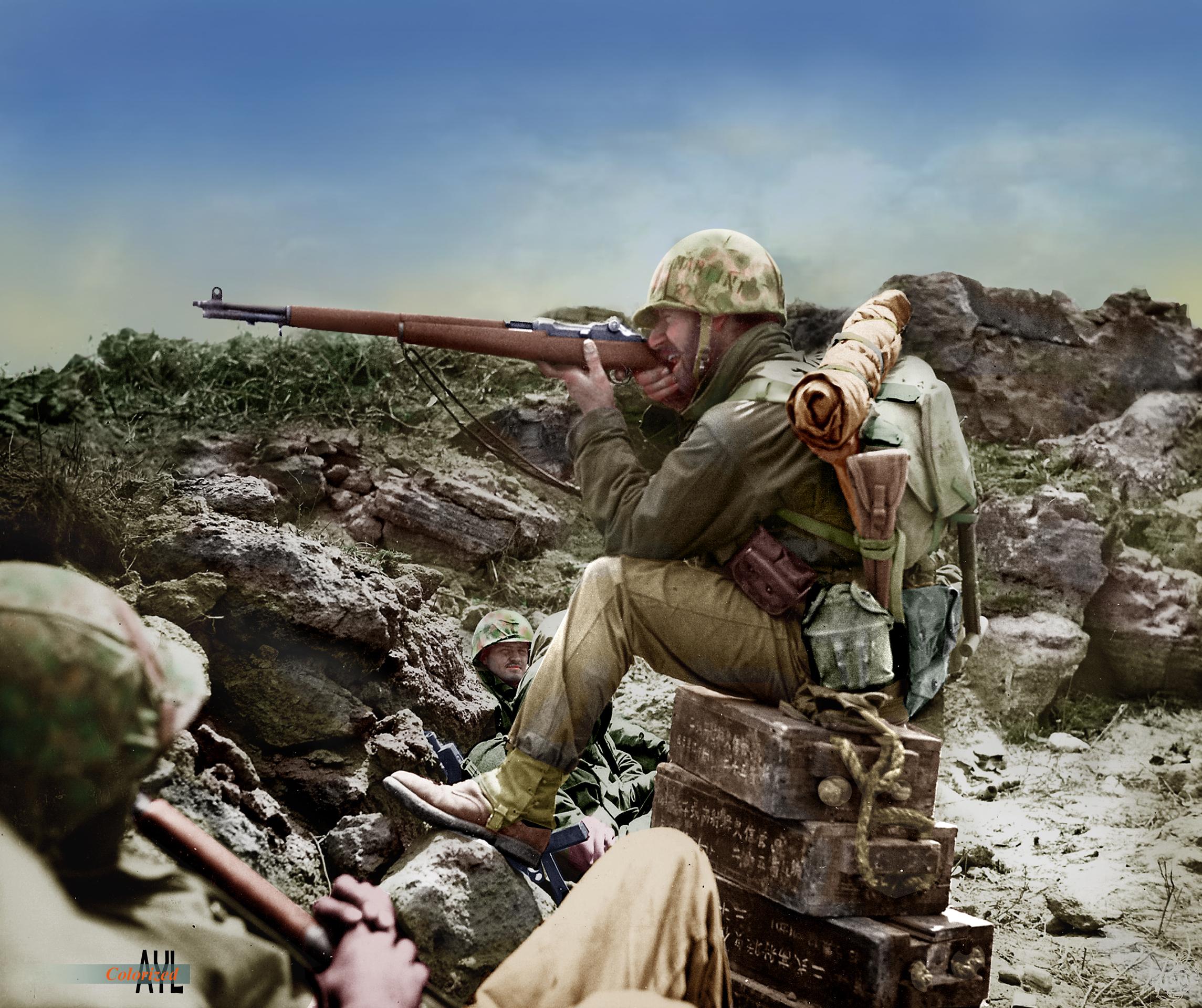 U.S. Marine aiming his rifle in practice during a lull in the Battle of Iwo Jima, colorized from
