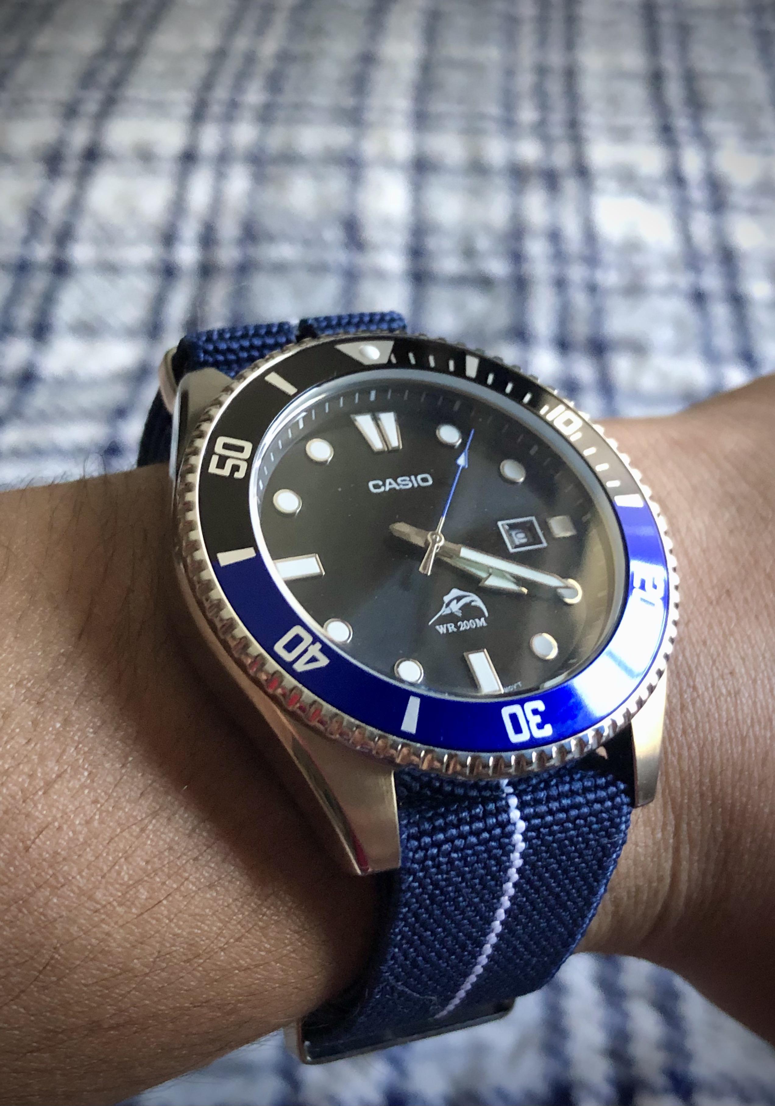 The Batman on a blue striped nato strap. casio