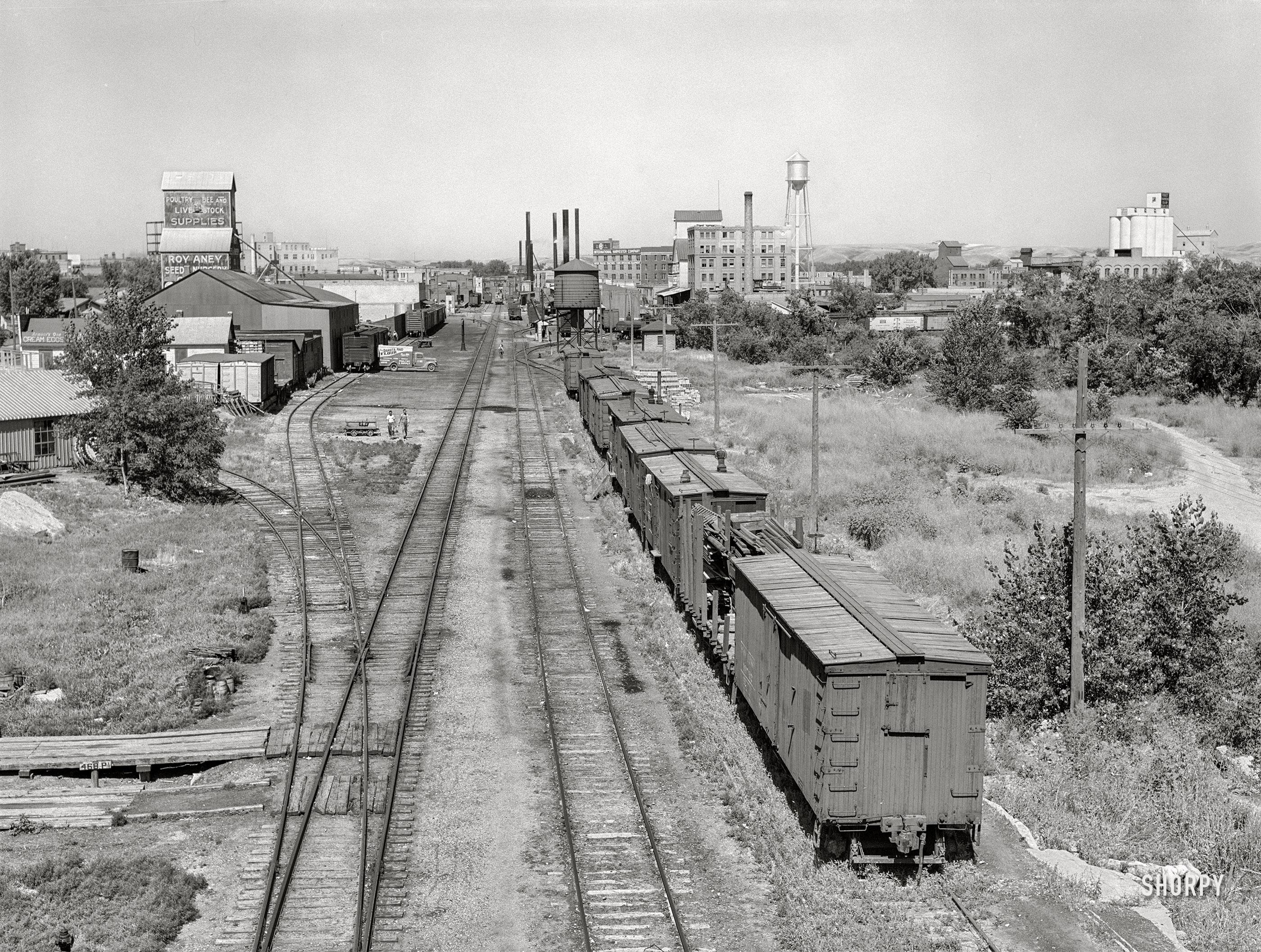 August 1941. "Rail yard and grain elevators. Minot, North Dakota," a.k
