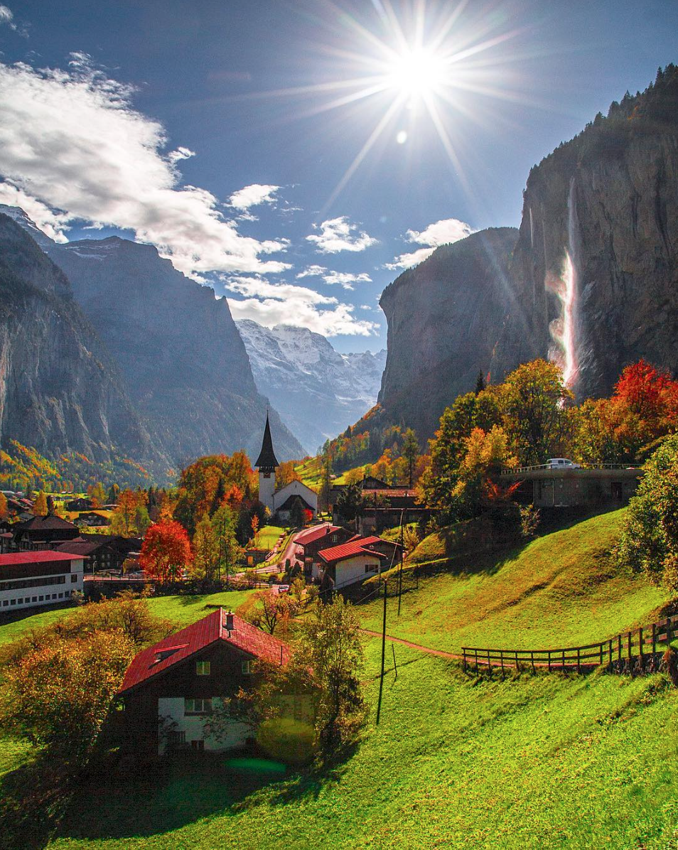 Small village in Switzerland overlooking a mountainous waterfall r/pics
