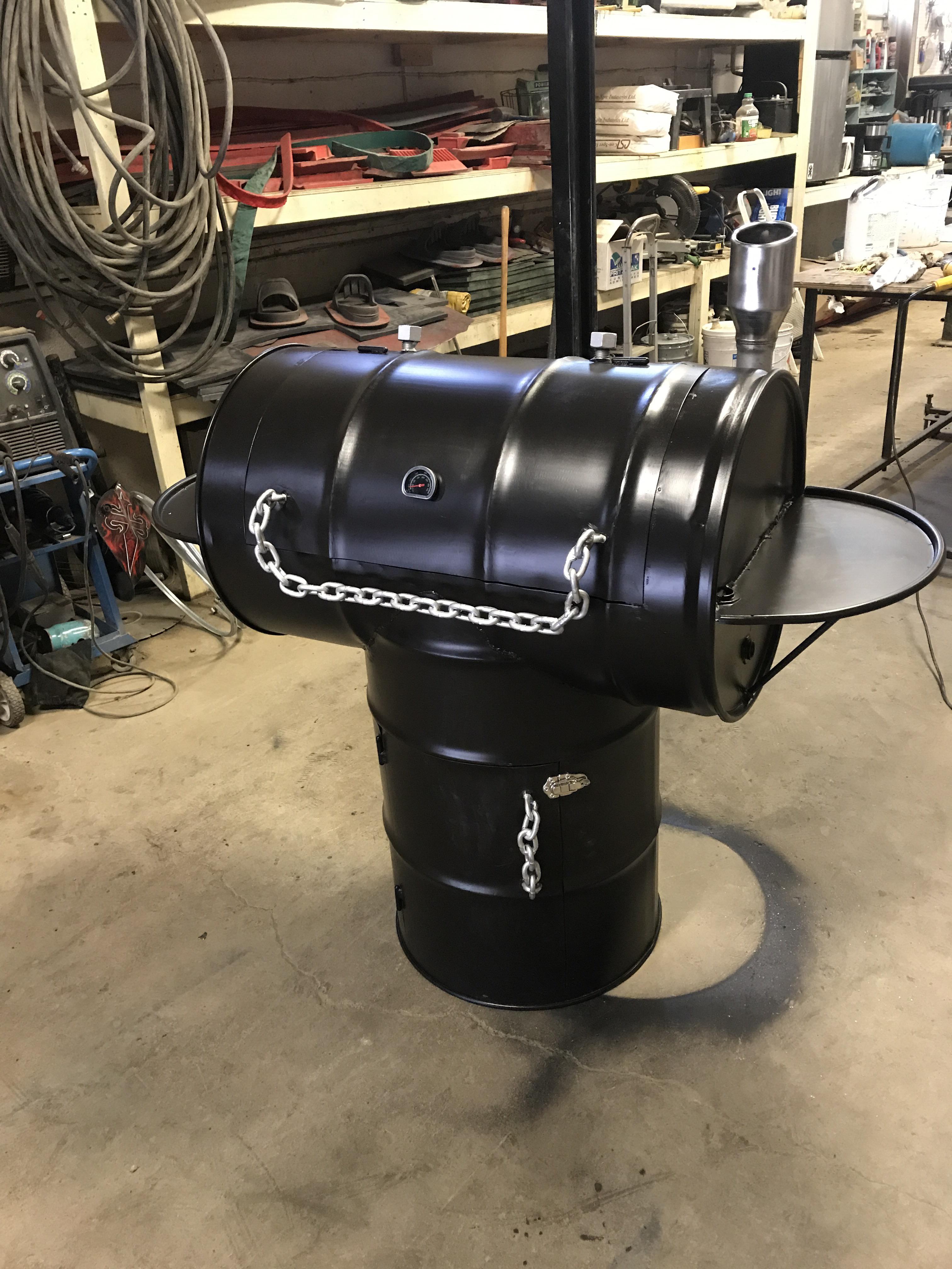 Pit style smoker I made, uses briquettes in the top barrel and bottom