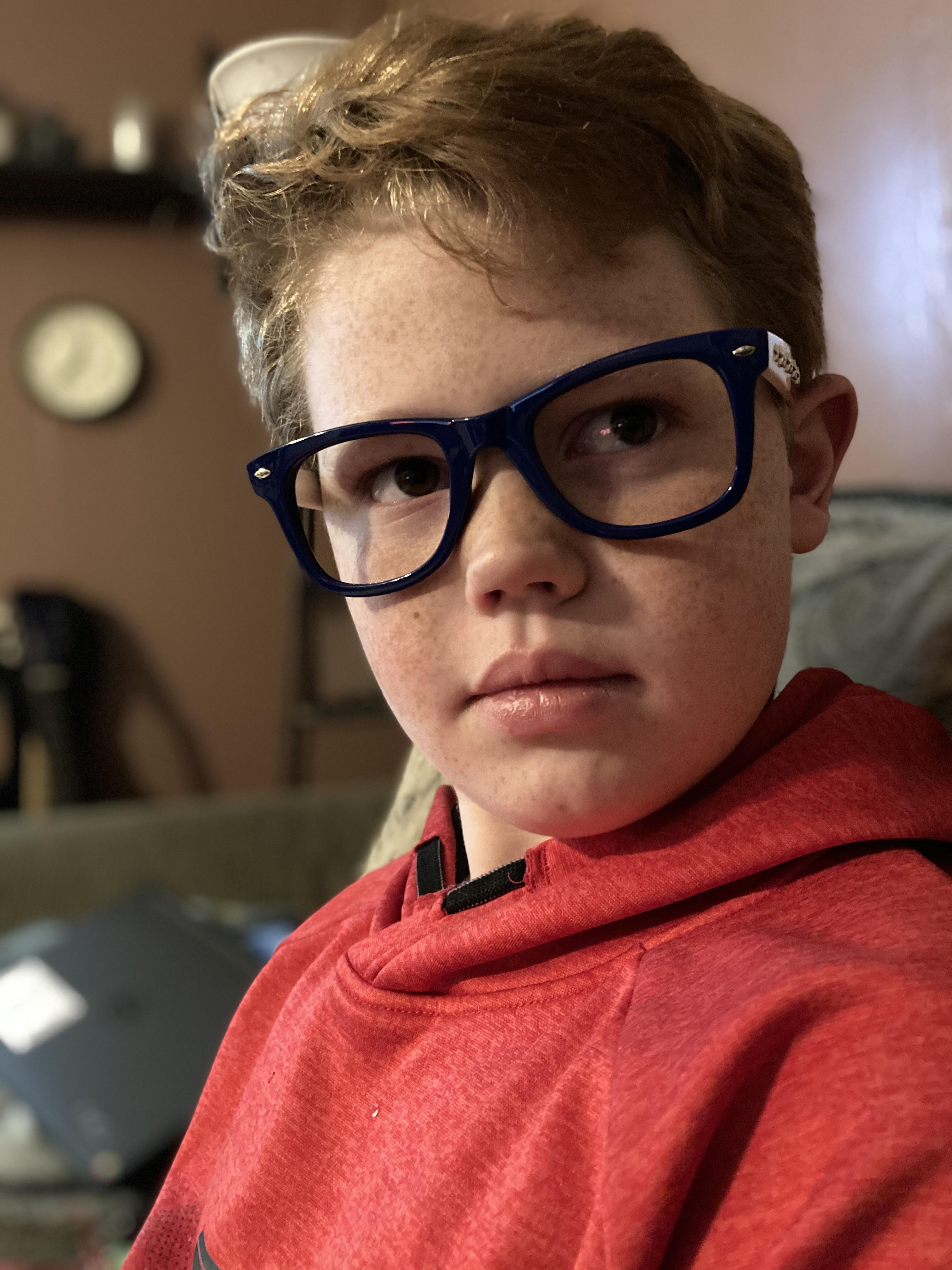My handsome son thinking he has to put glasses on to be considered a