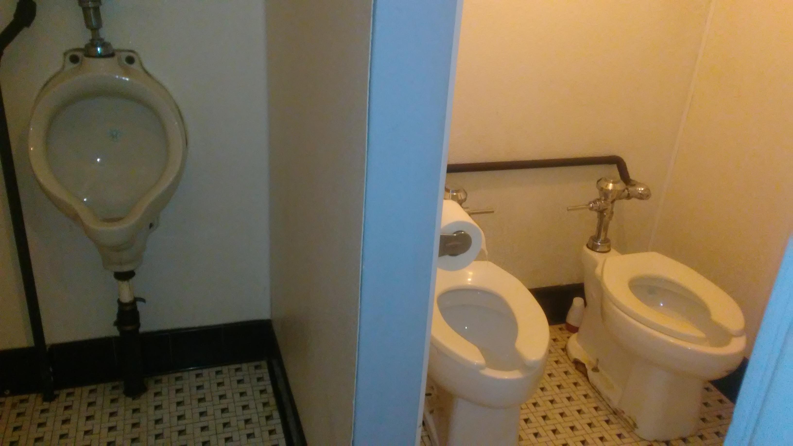 At a movie theater, the urinal is separated, but the toilets are not
