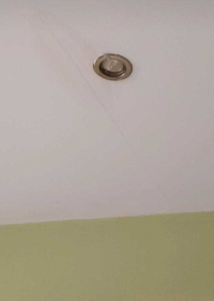 Water is leaking from the shower through a kitchen light. What do I do