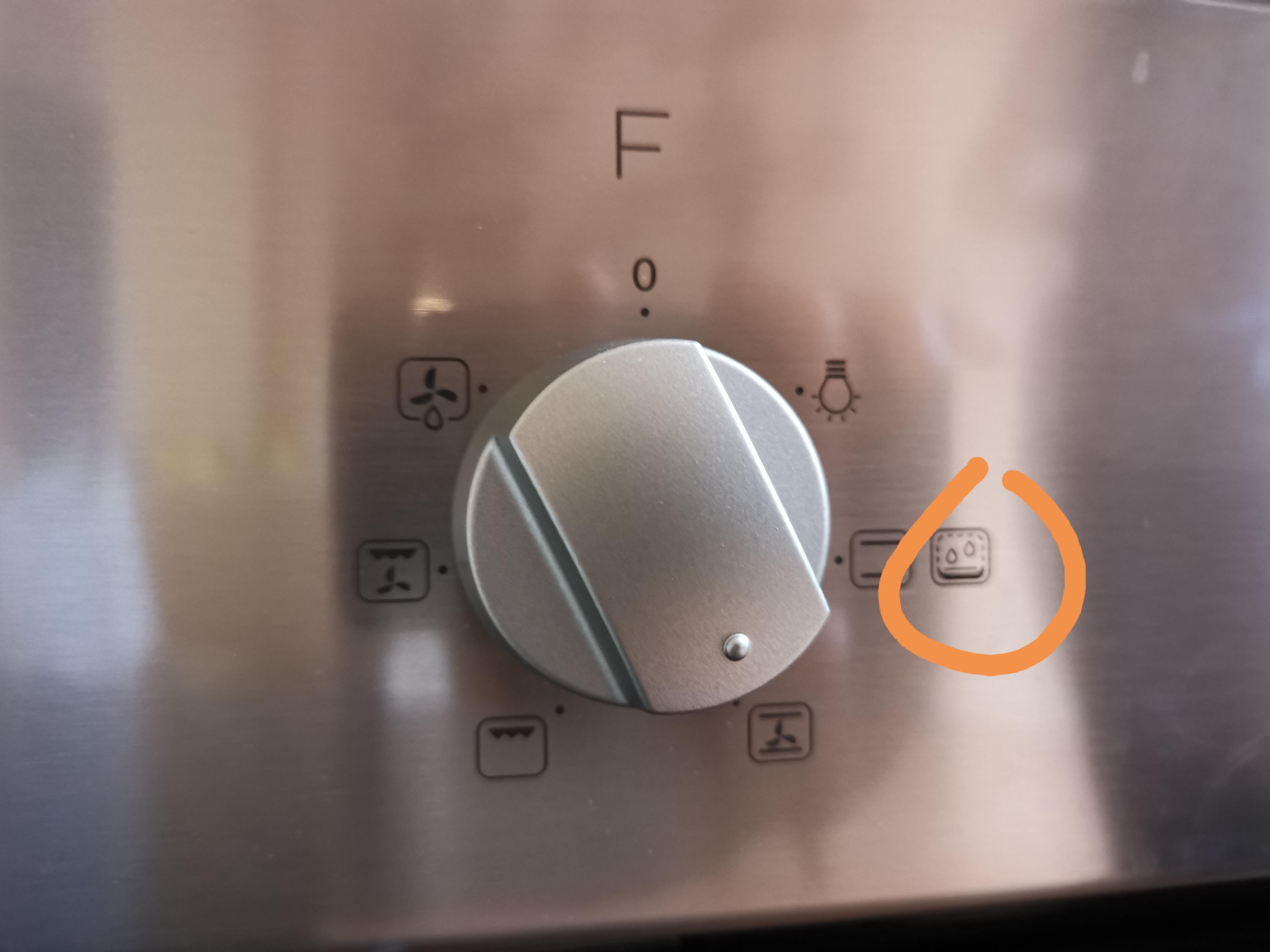 What is this symbol? My oven starts smoking with a really nasty smell