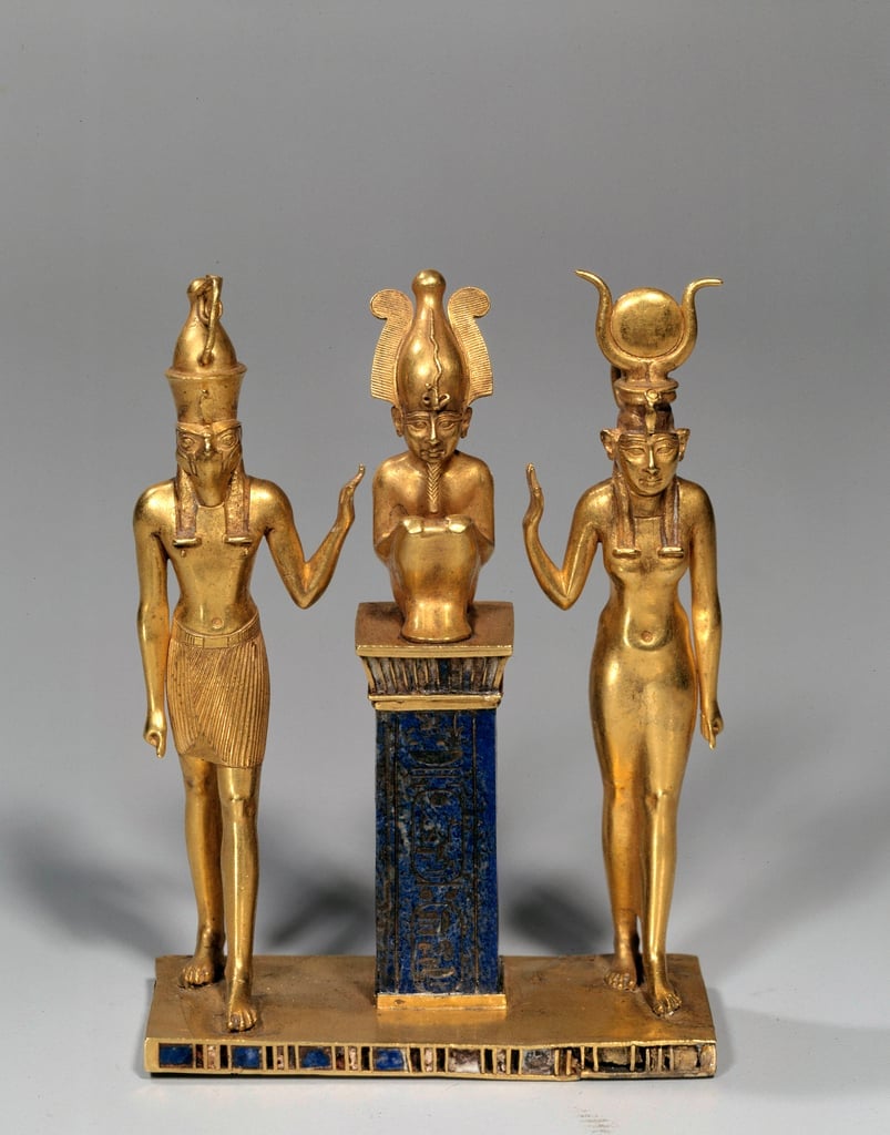 The family of Osiris. Osiris on a lapis lazuli pillar in the middle, flanked by Horus on the