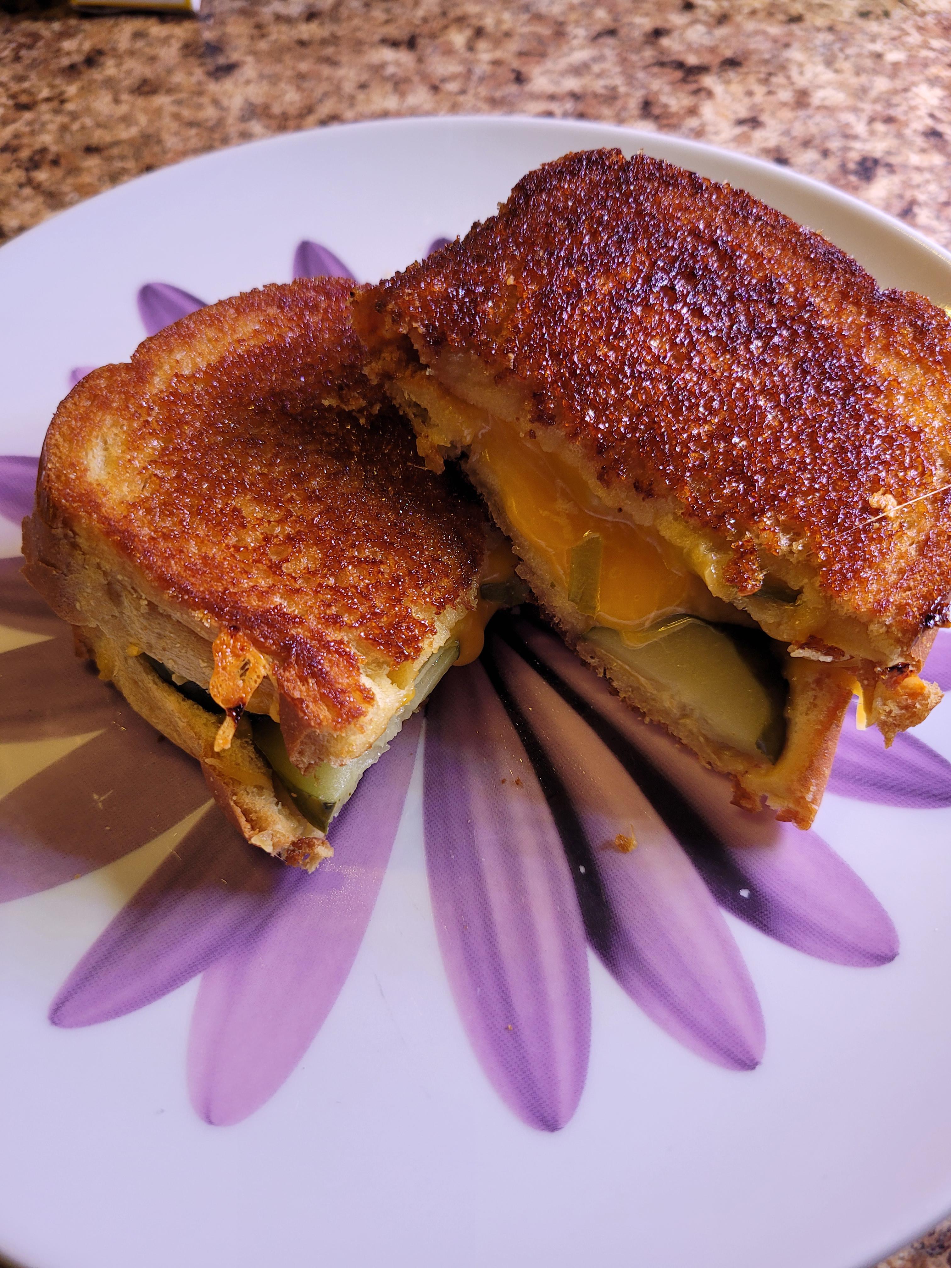 Grilled cheese with sharp cheddar and pickles on brioche with