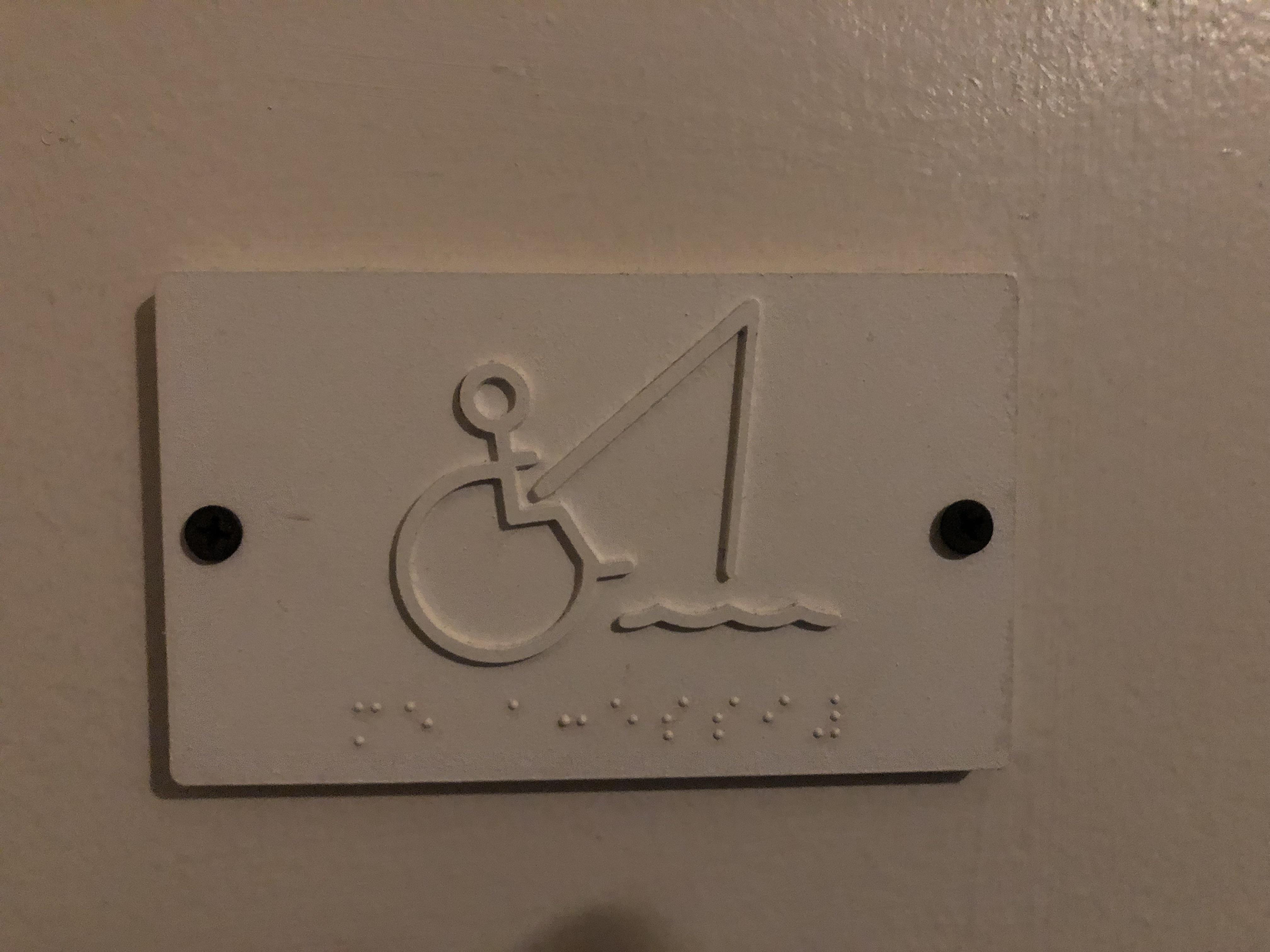 Bathroom sign for the men’s handicap stall. Can’t confirm if this is