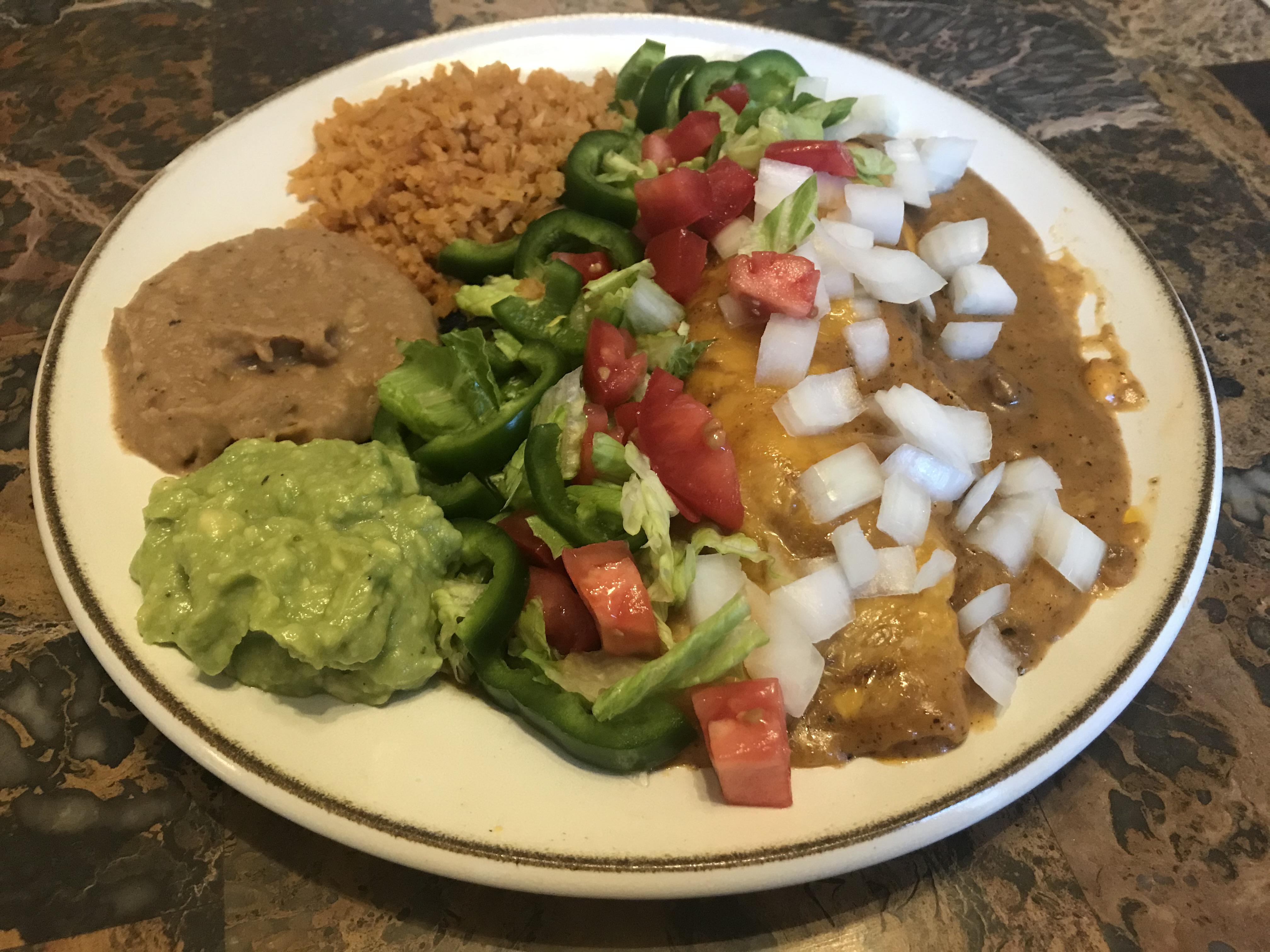 Smothered ground beef burrito, homemade refried beans, Mexican rice