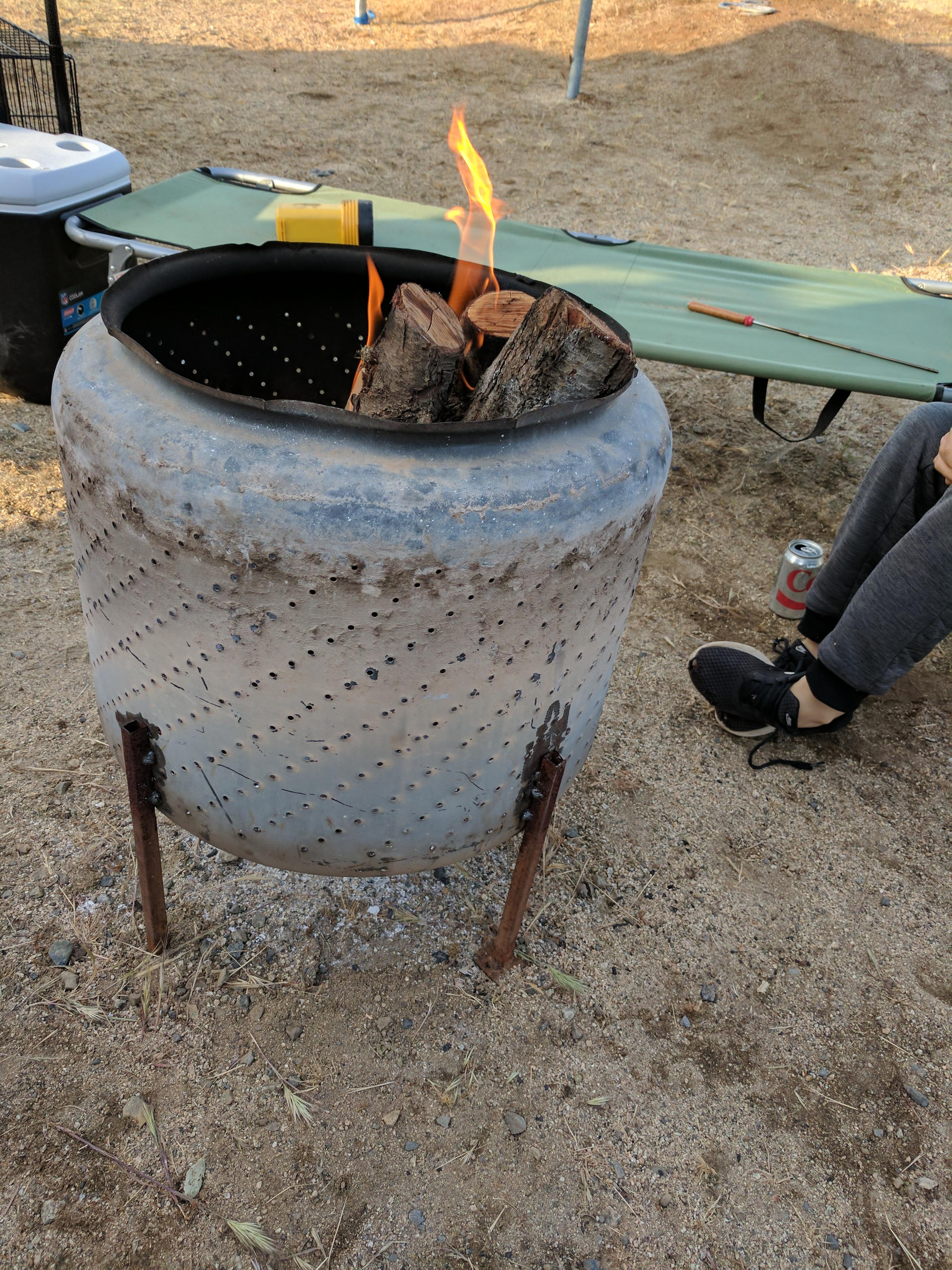 The inside of an old washing machine makes a great camping fire pit