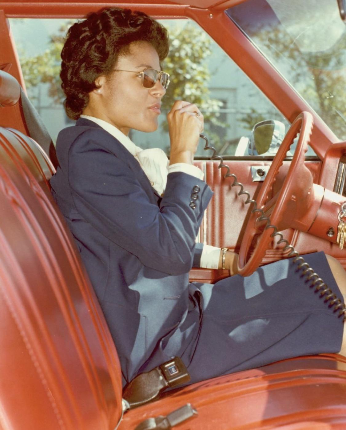 FBI Special Agent Johnnie Gibson uses a car radio on assignment in the