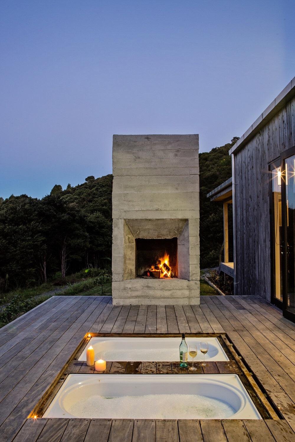 Outdoor bathtubs on the patio of a home in the bush in New Zealand. r/CozyPlaces