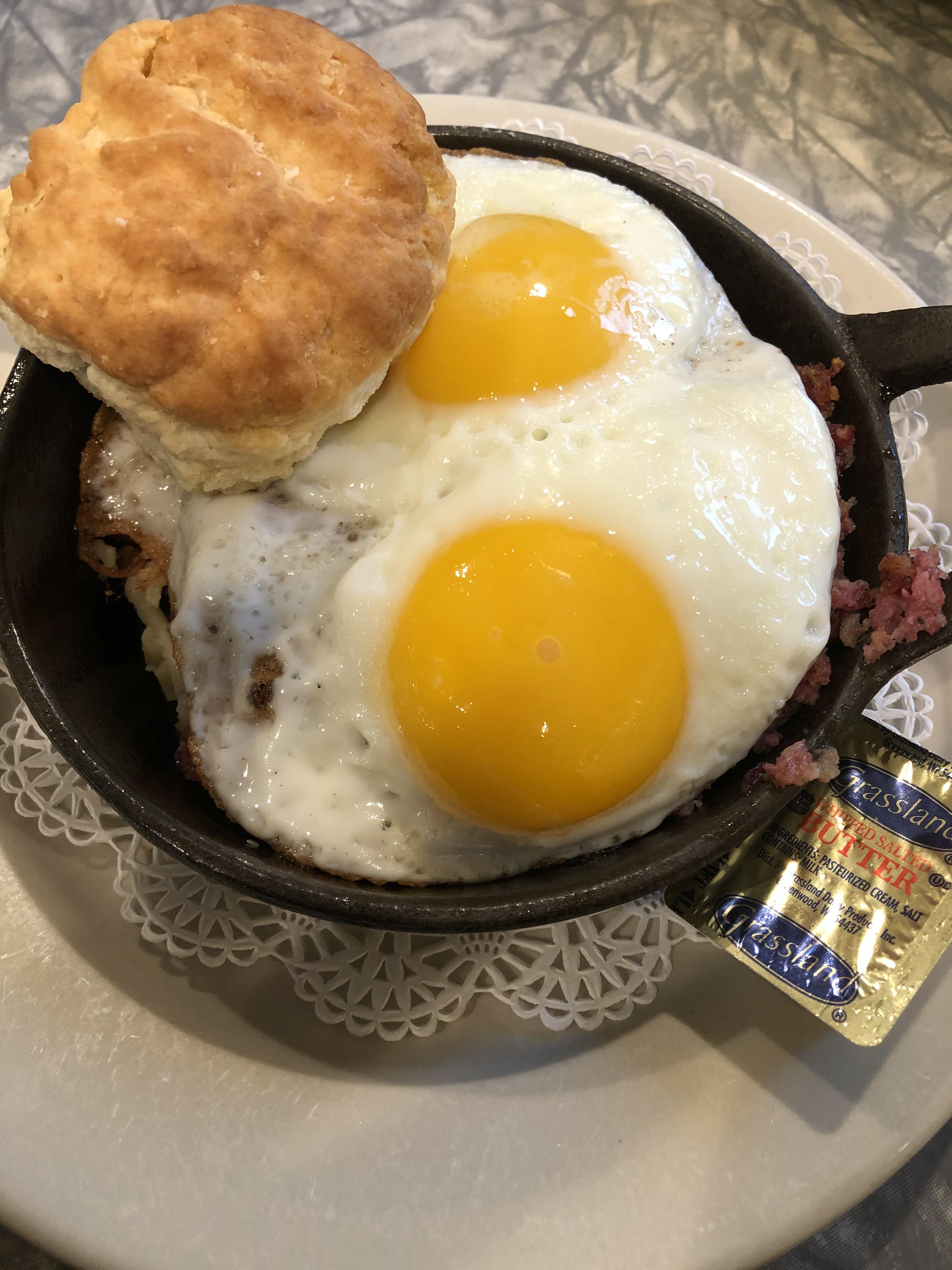 Cornrd beef hash topped with over easy eggs PutAnEggOnIt