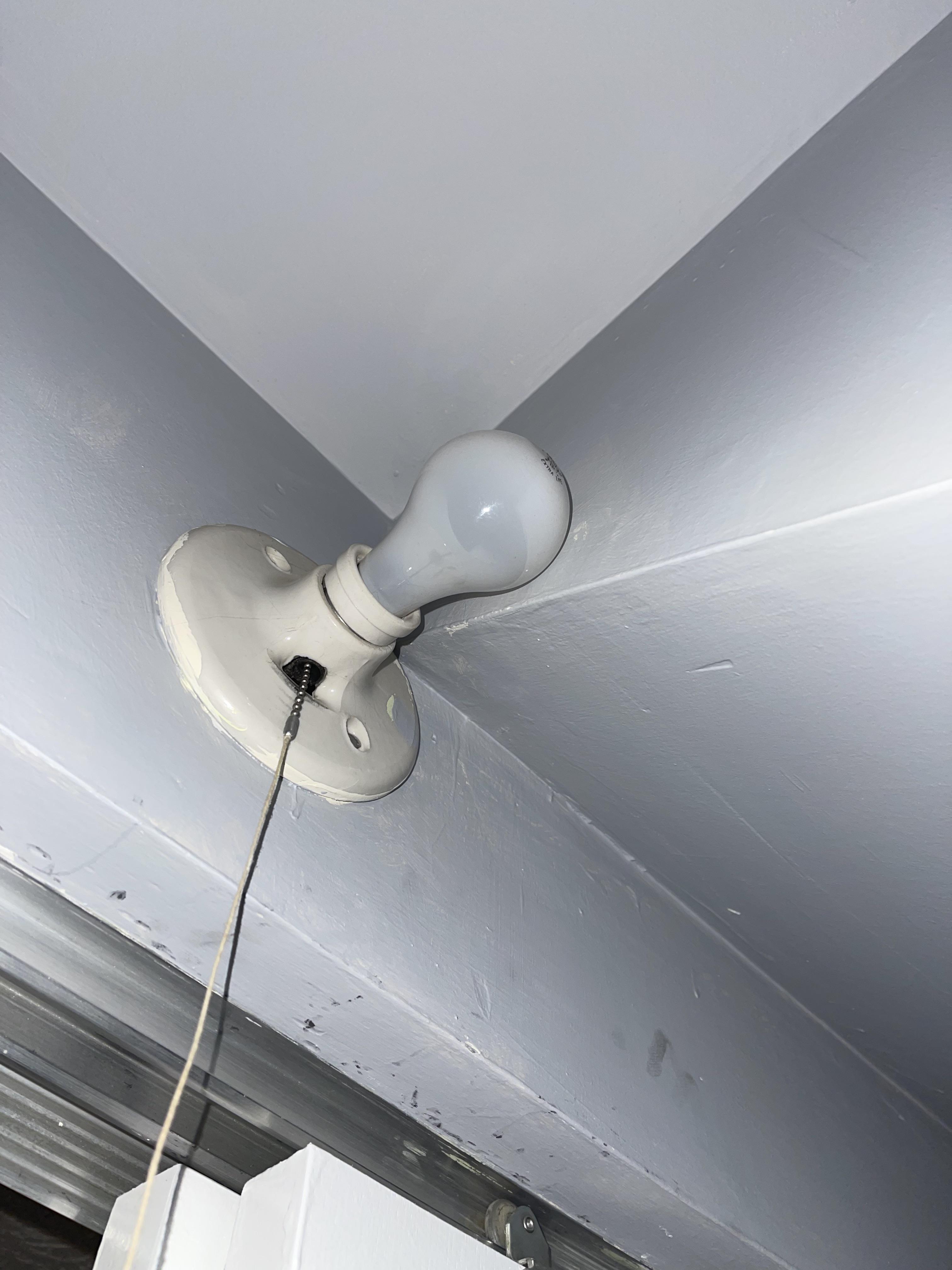 Not sure why this closet light fixture was installed so close to the wall under the stairs. It