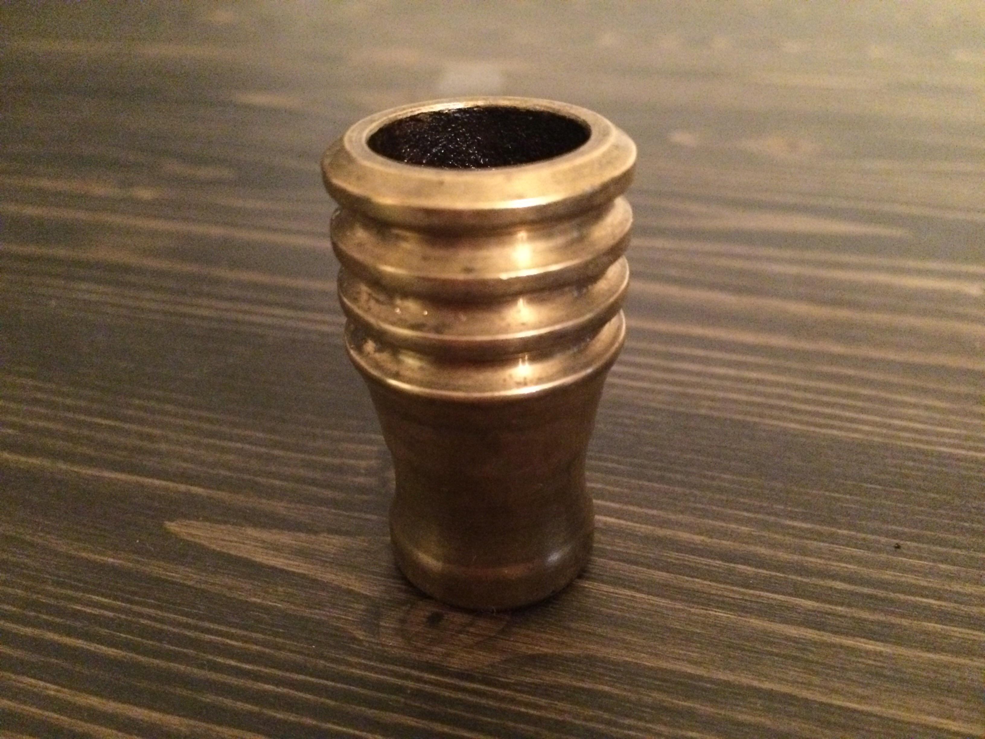 This little brass thingy. It's hollow and looks burned on the inside