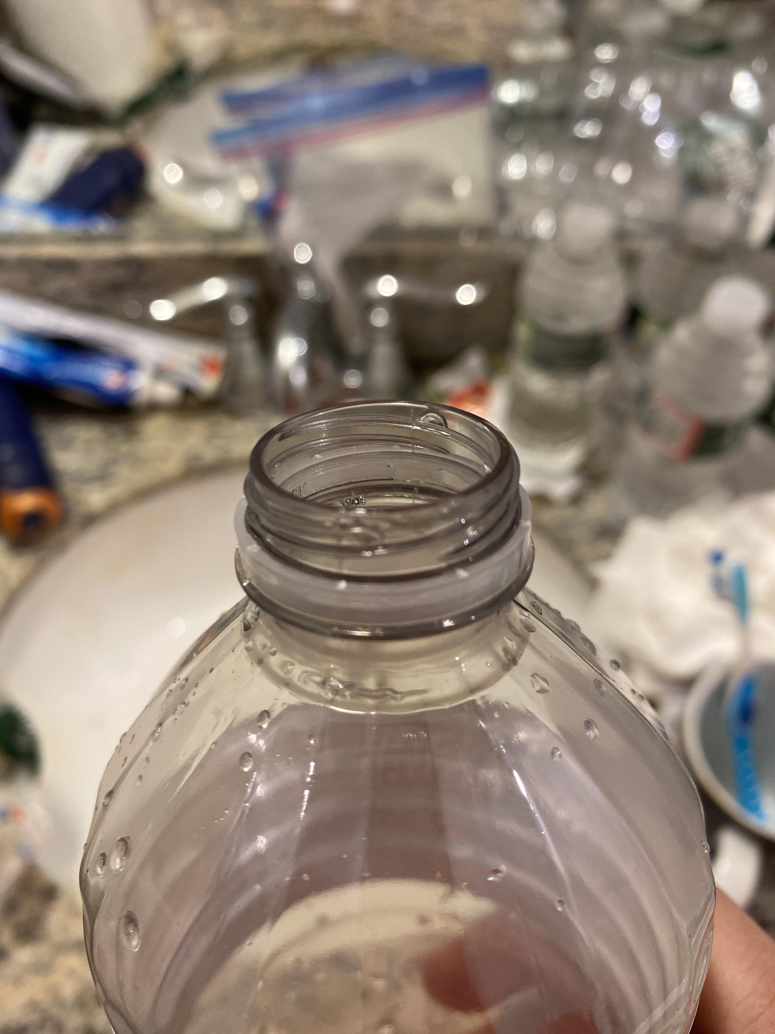 Why is there a small black dot on the top of my water bottle? Look
