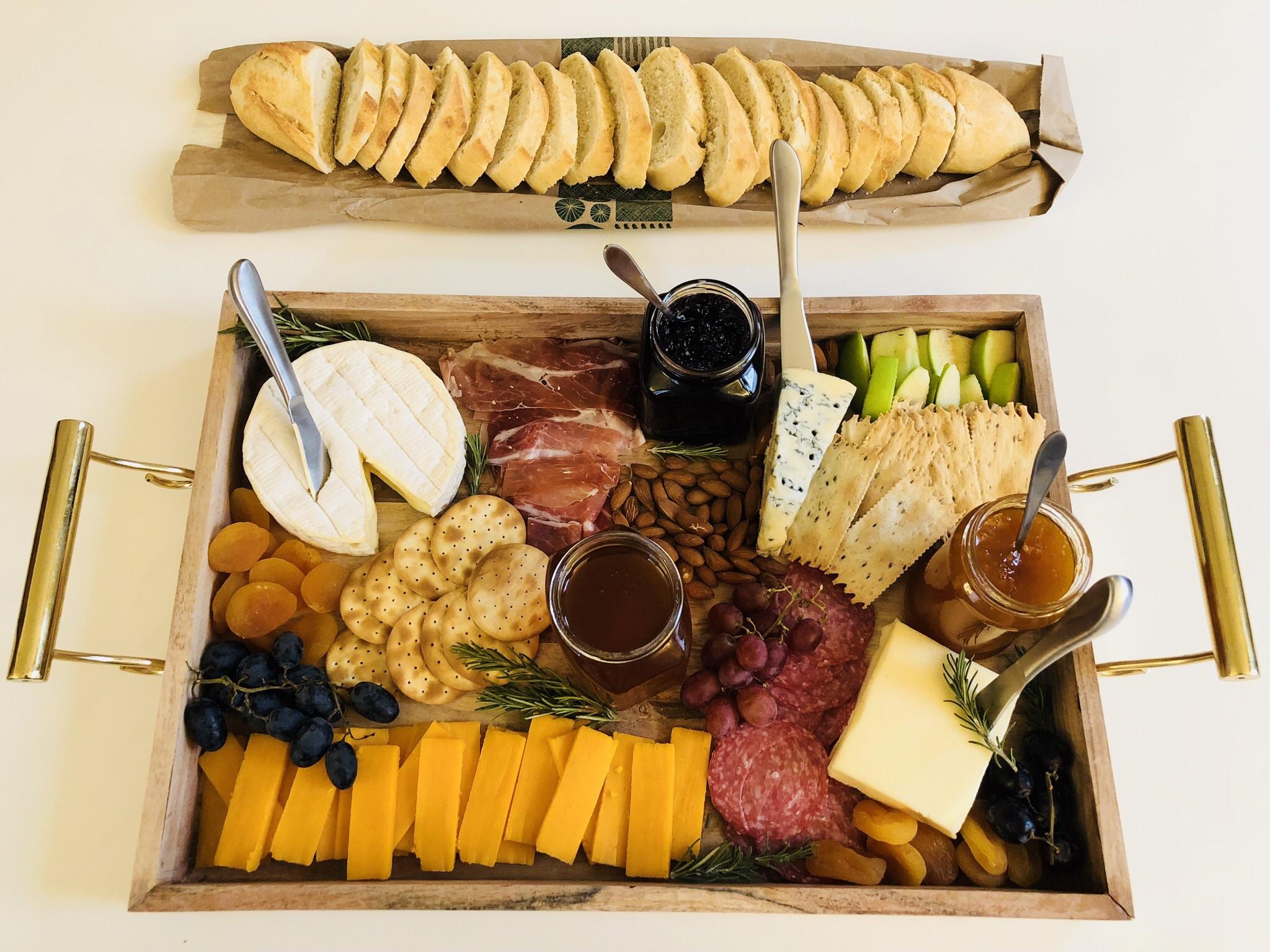 NYE Cheese Board with honey, jam, grapes, apples, dried apricots
