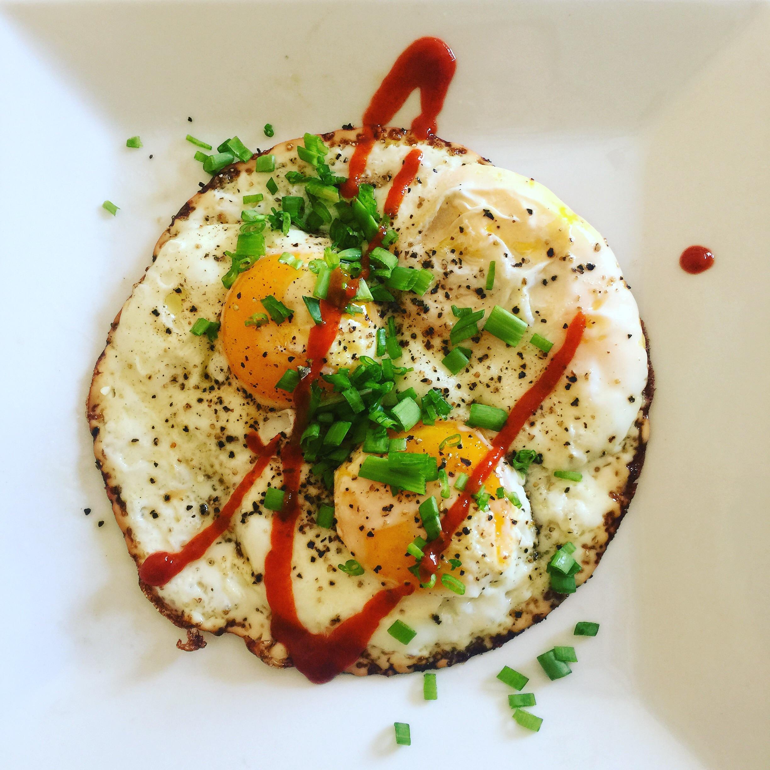 [homemade] olive oil fried eggs with chives and Sriracha. r/food