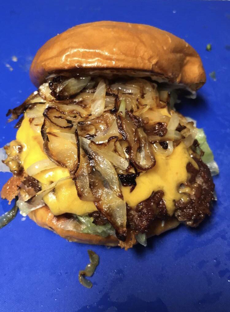 Smash burger with caramelized onions on a brioche bun. Made at home