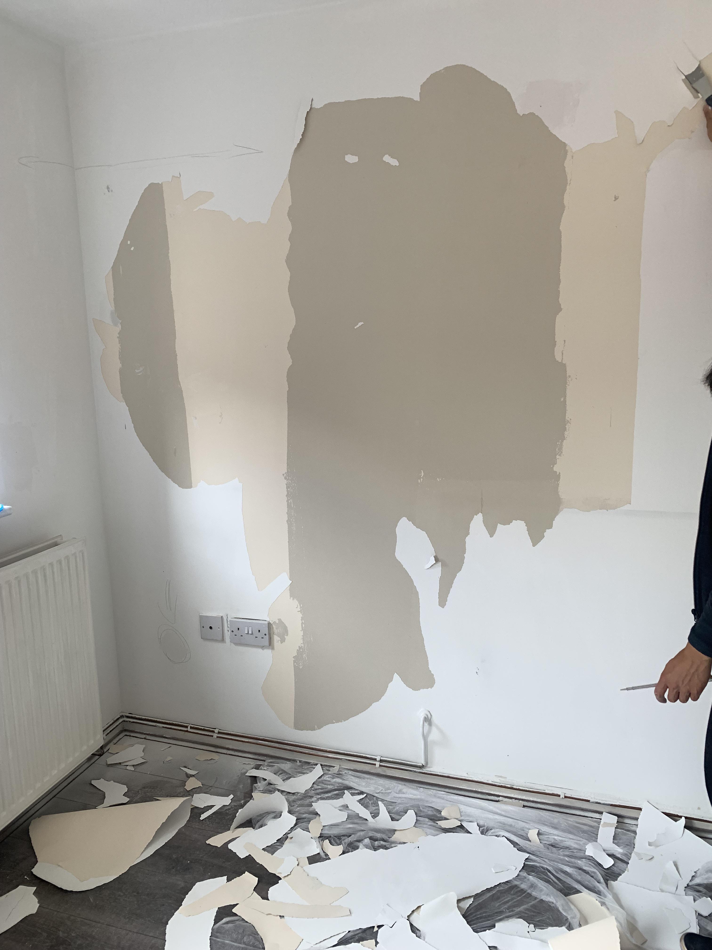 Can someone explain what has happened here? Could this be wallpaper or plasterboard that has