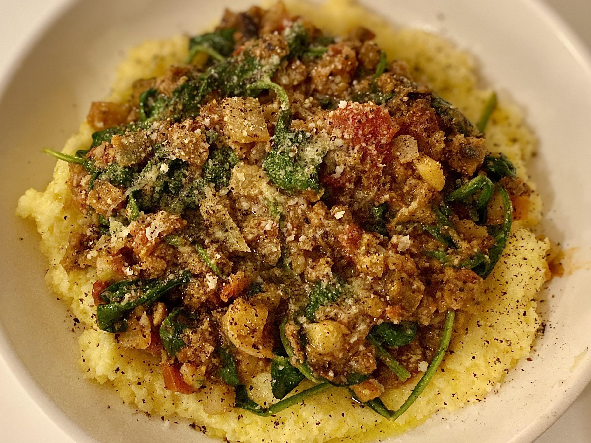 Beyond meat, tomatoes, spinach, onions, garlic, eggplant over polenta