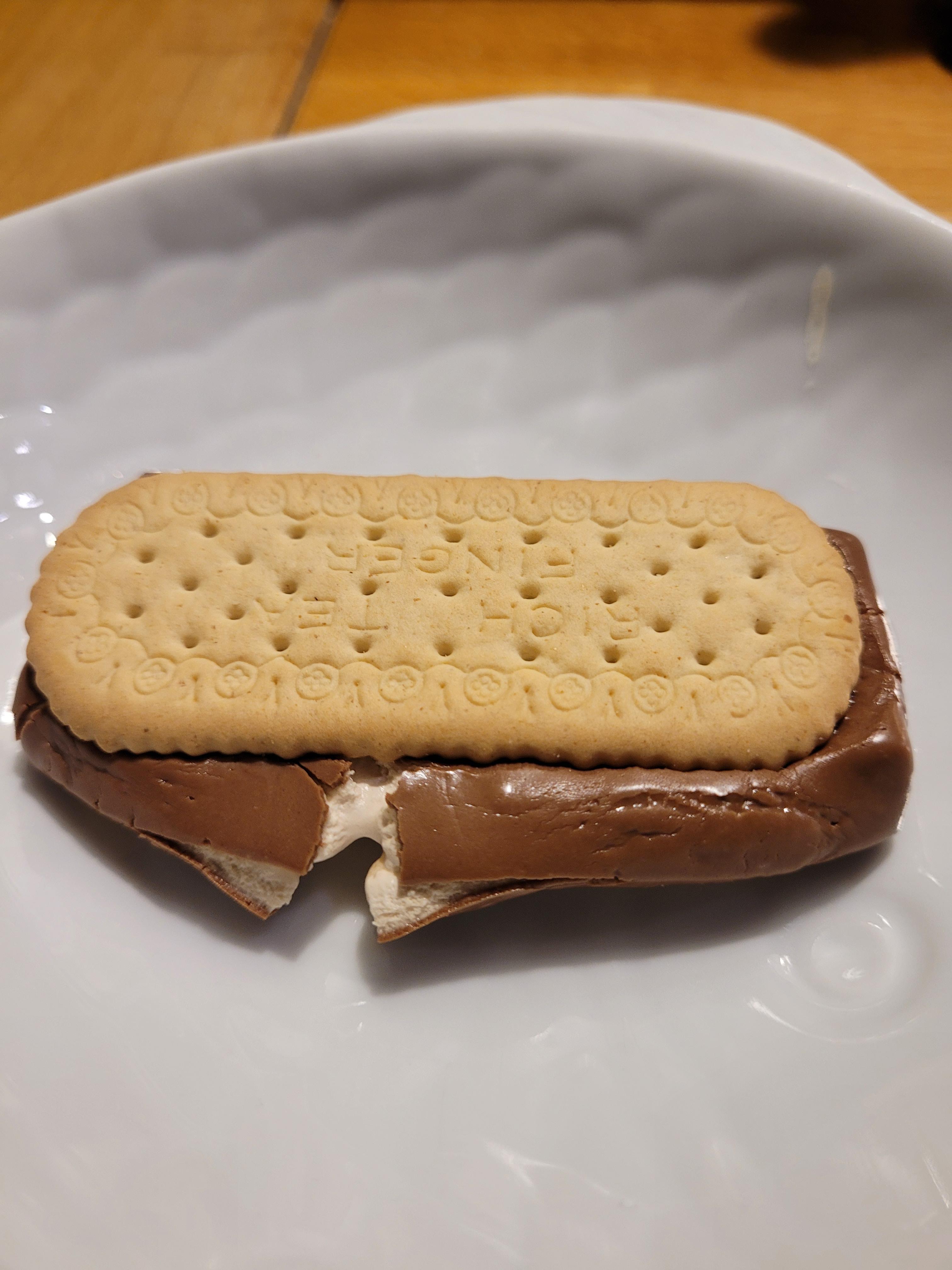 My daughter just invented the British s'more. Milky way between 2 rich