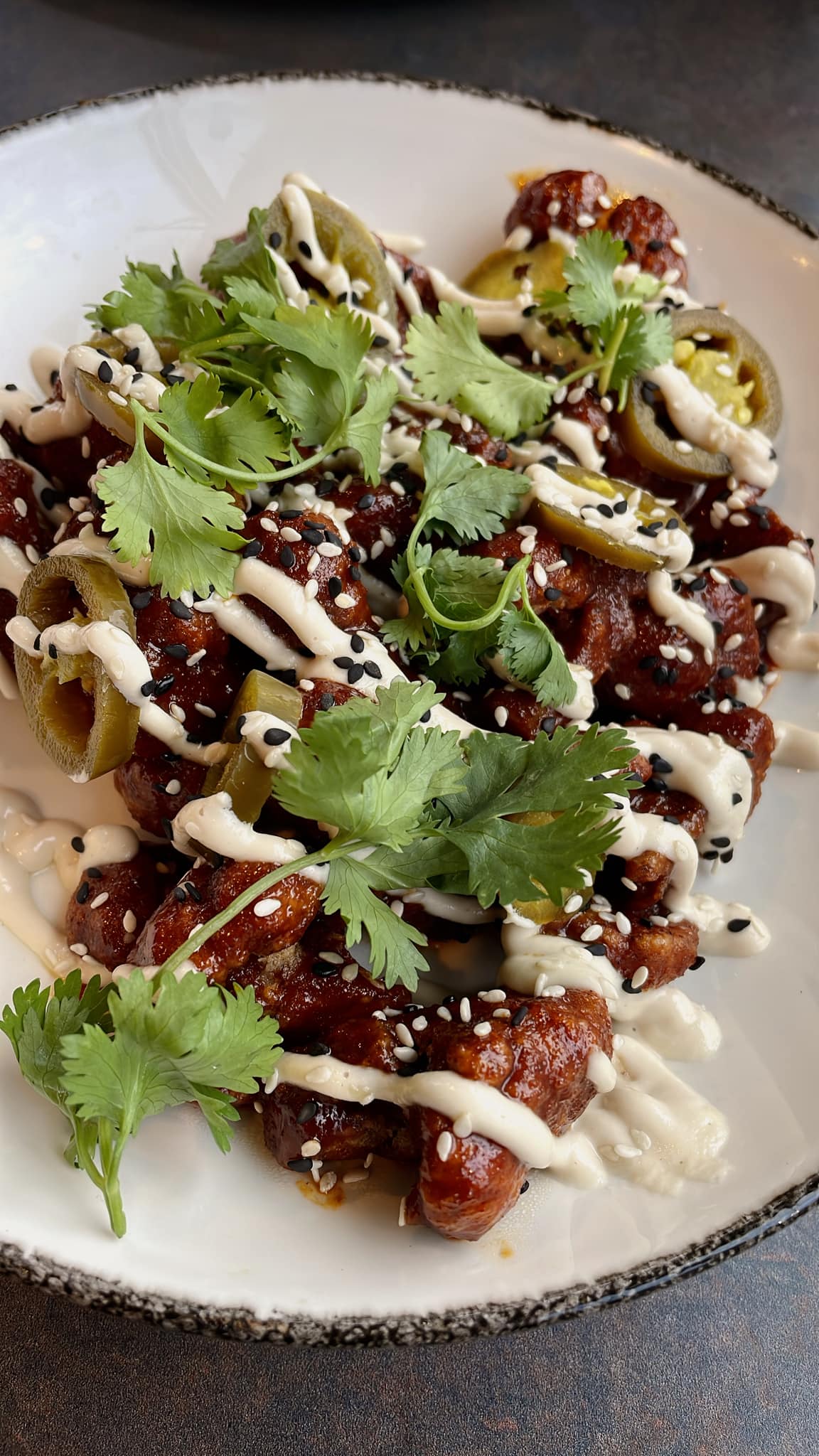 Tempura fried cauliflower bites toseed in sesame gochujang sauce