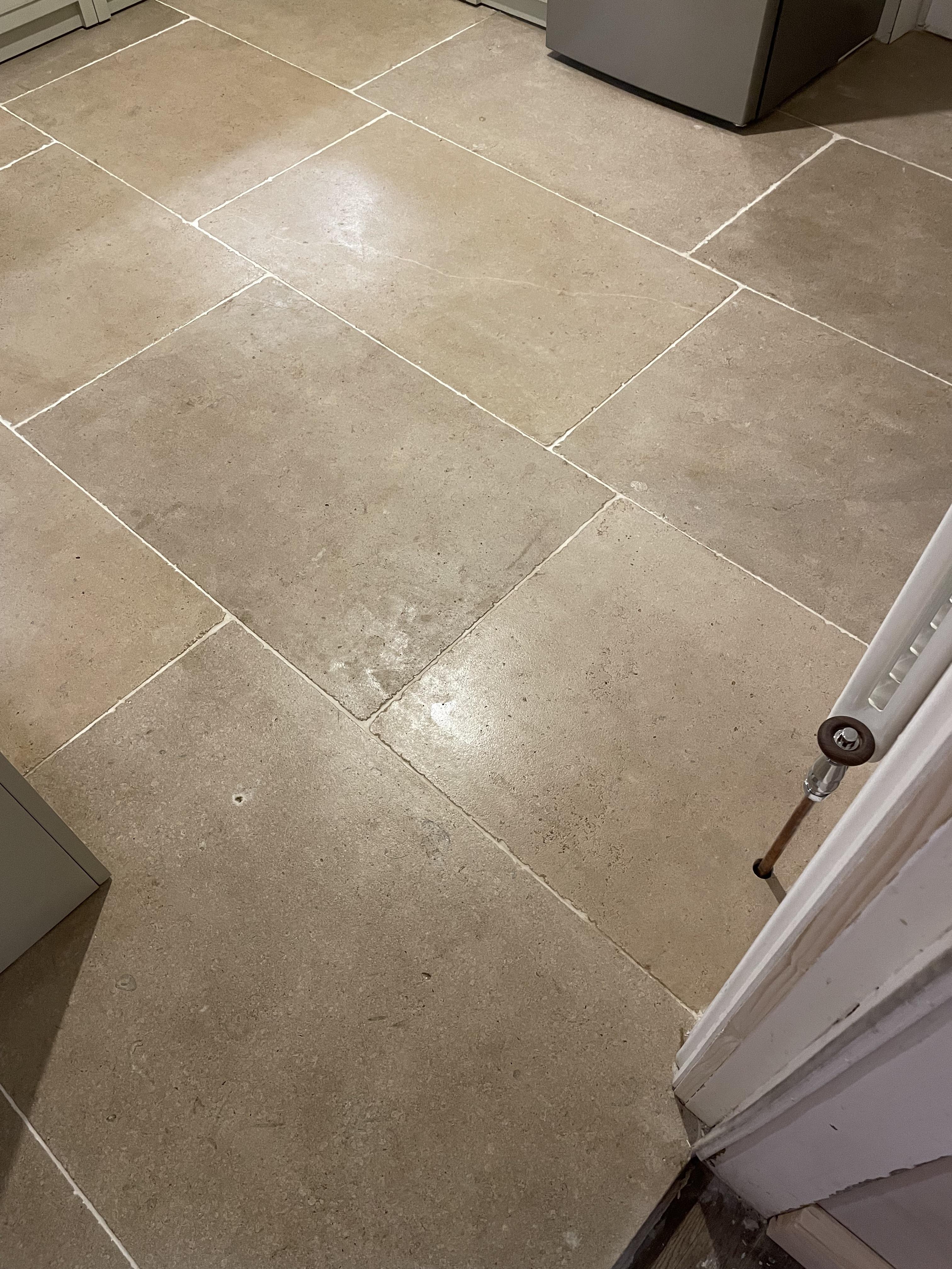 Stone floor sealer has left blotchy shiny marks, what can we do to fix