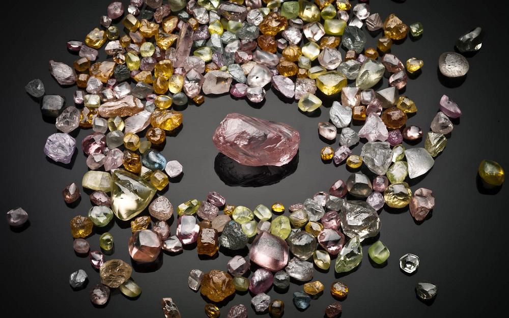 Raw, uncut diamonds of various colors. r/interestingasfuck