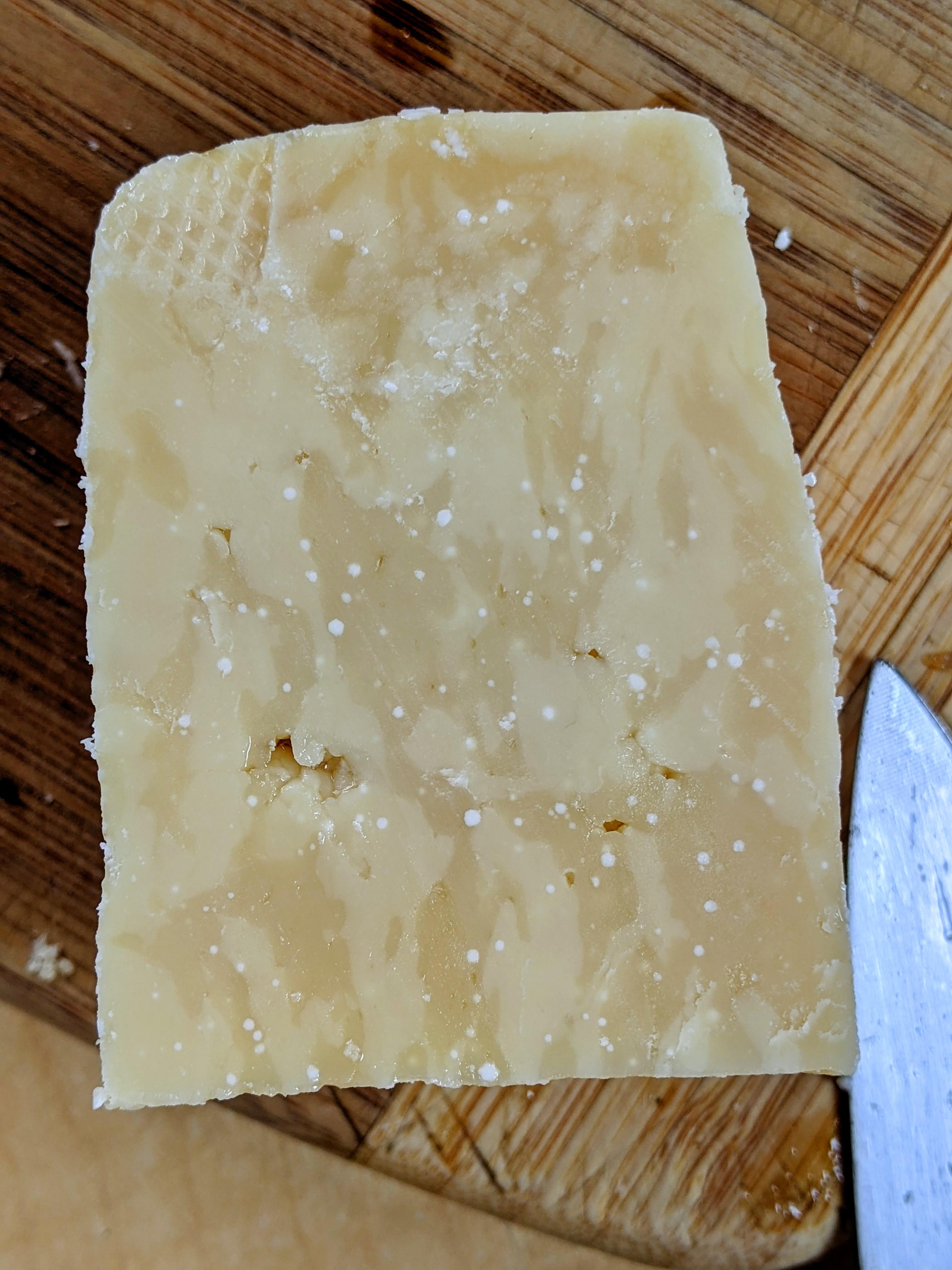 Crystals growing in a 4 year old parmesan. Note the interesting mottling. Intensely fruity with