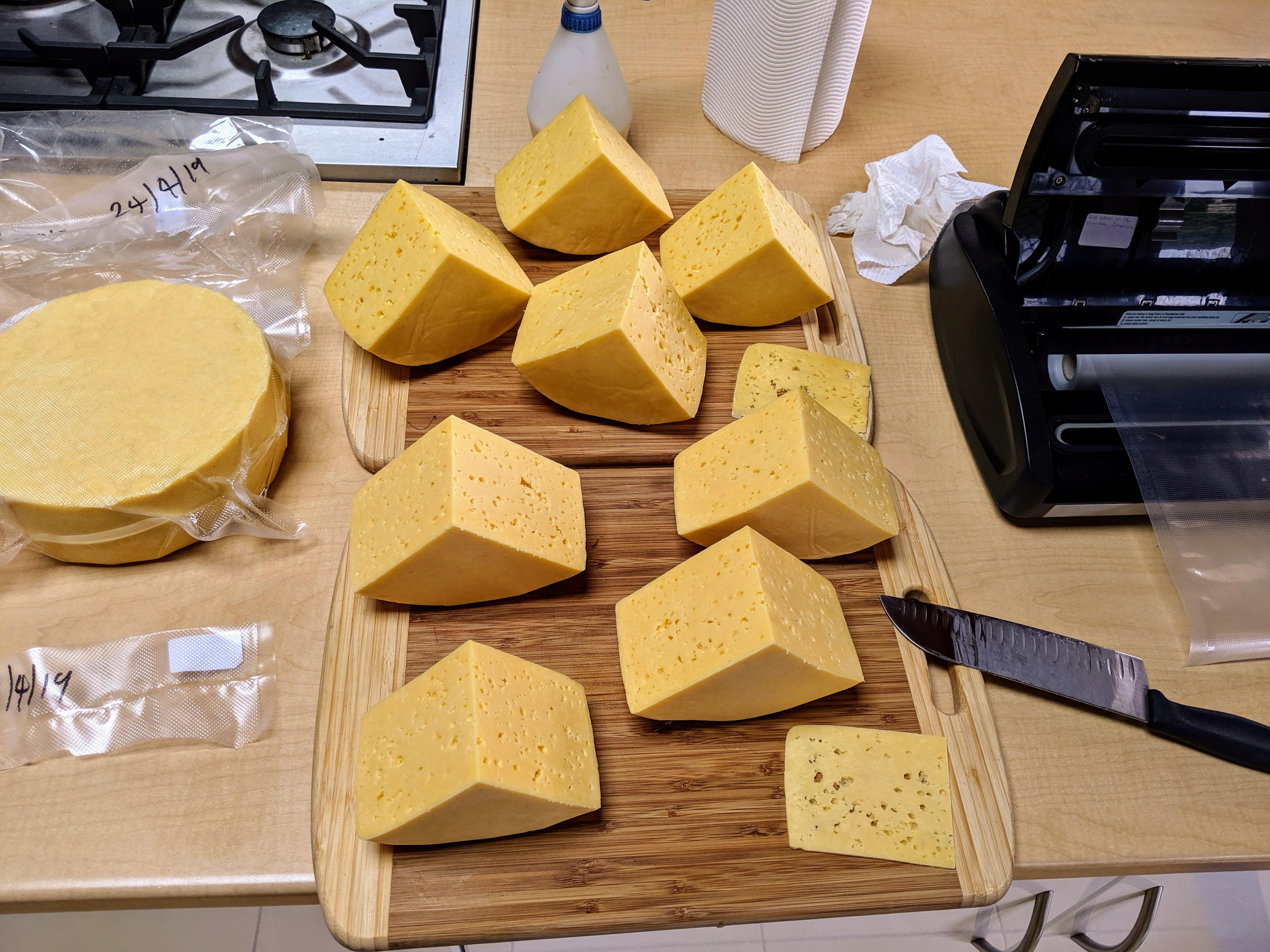 Splitting and re packing April's home made Alpine style cheeses for