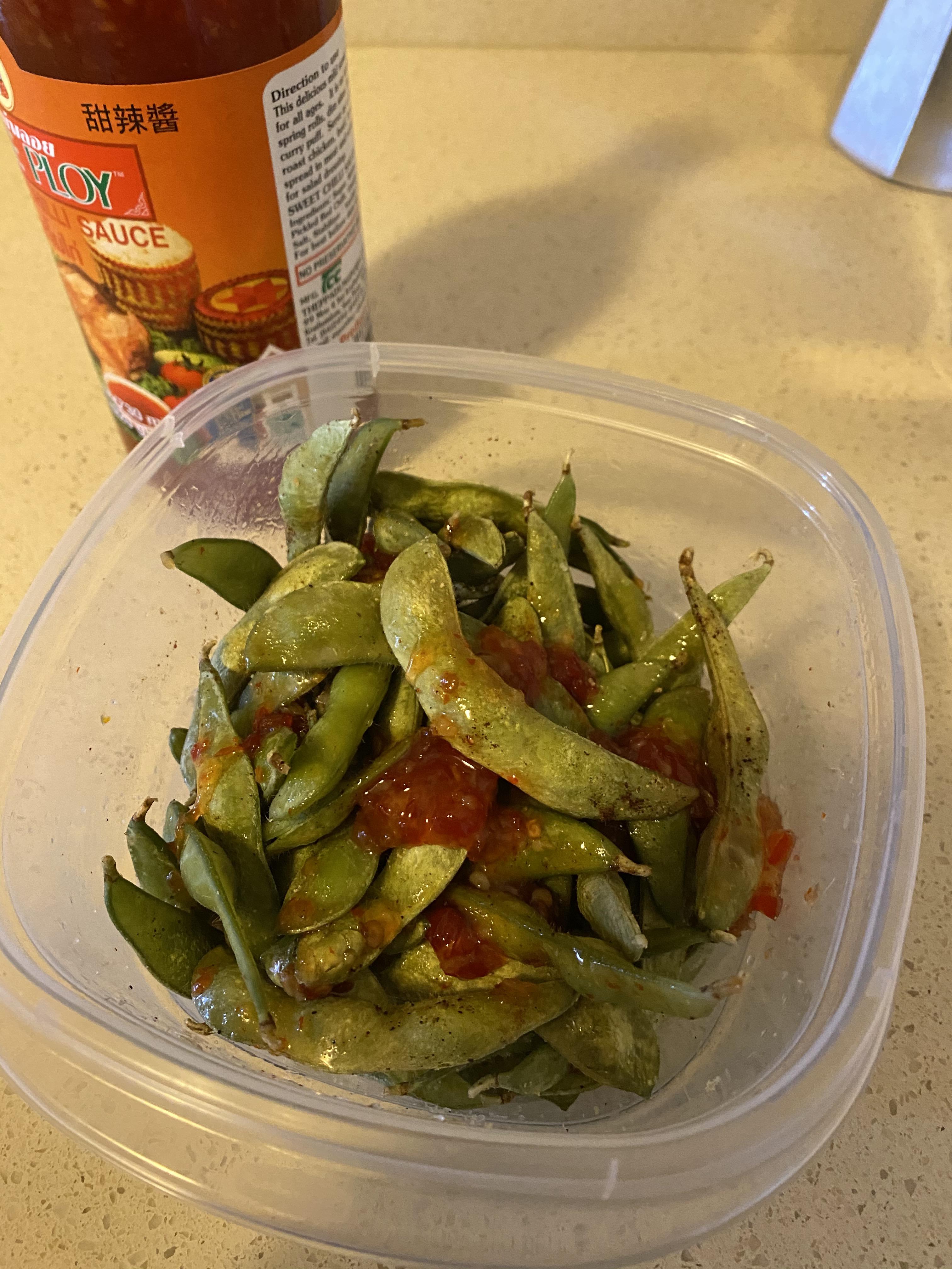 Microwaved edamame with sweet chili sauce and garlic salt. Happy