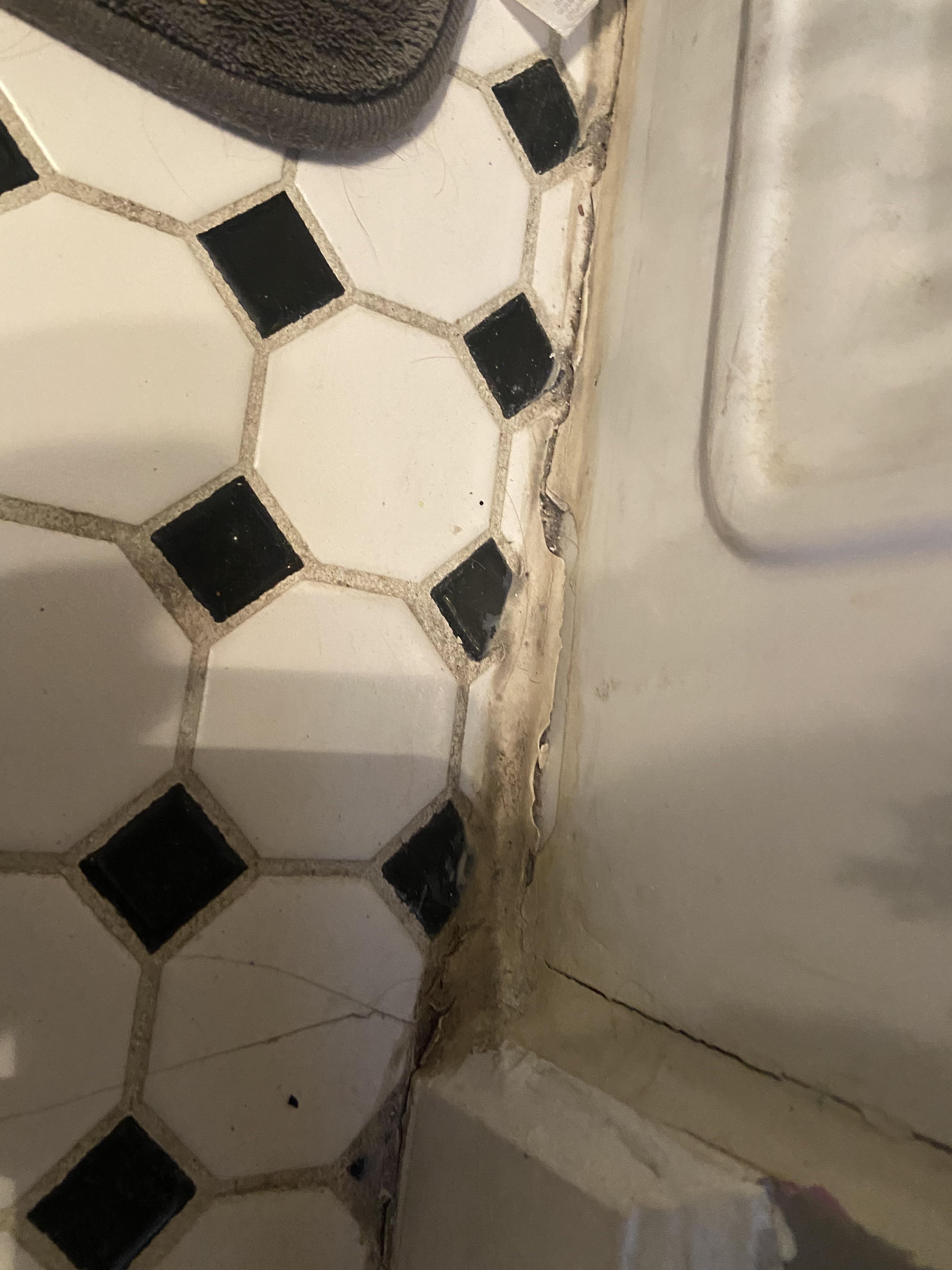 How to remove this rock hard caulking/ sealant around bottom of tub and