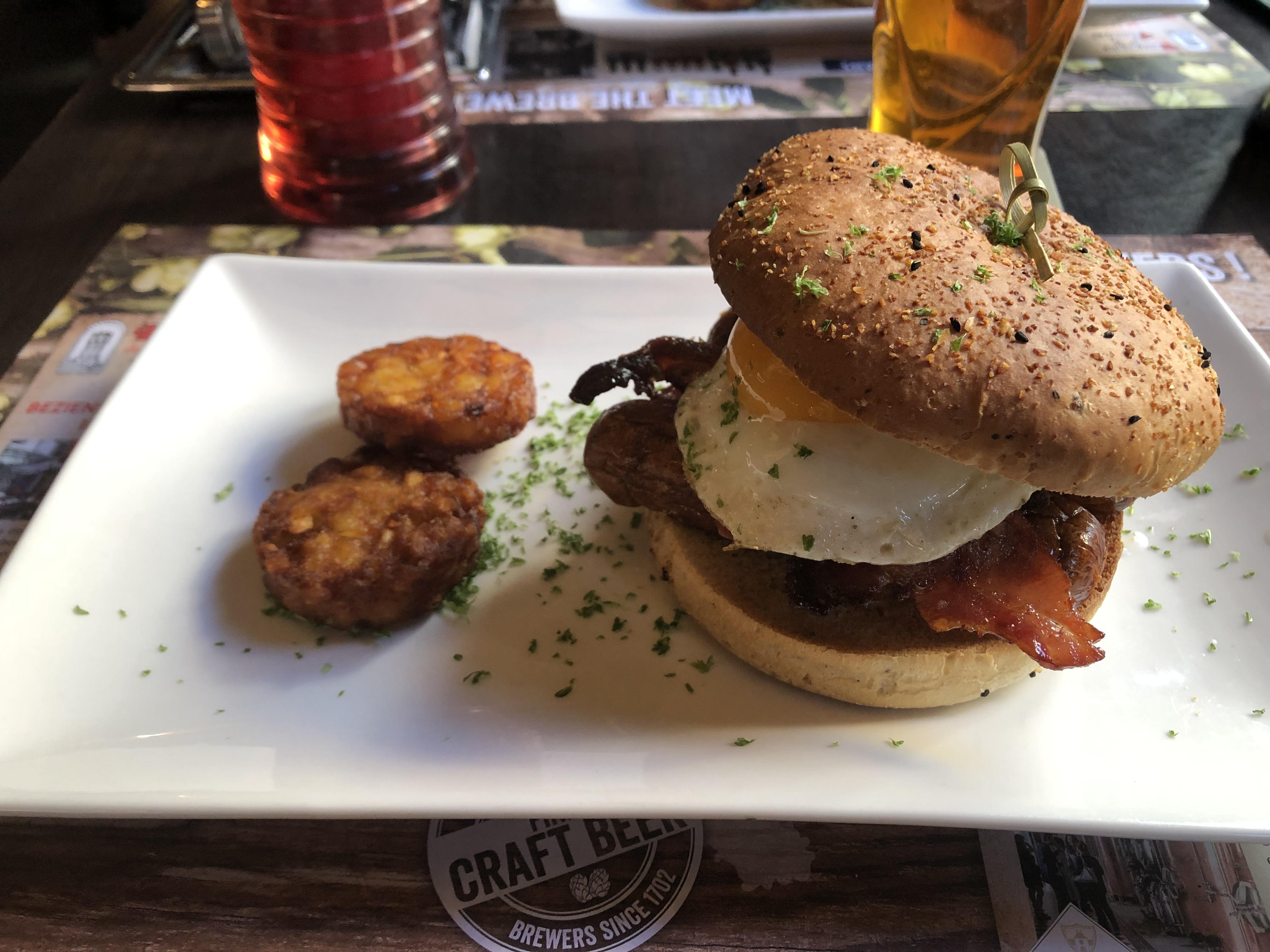 [I ate] Breakfast Bap with Bacon, Sausage and Fried Egg. Some hash