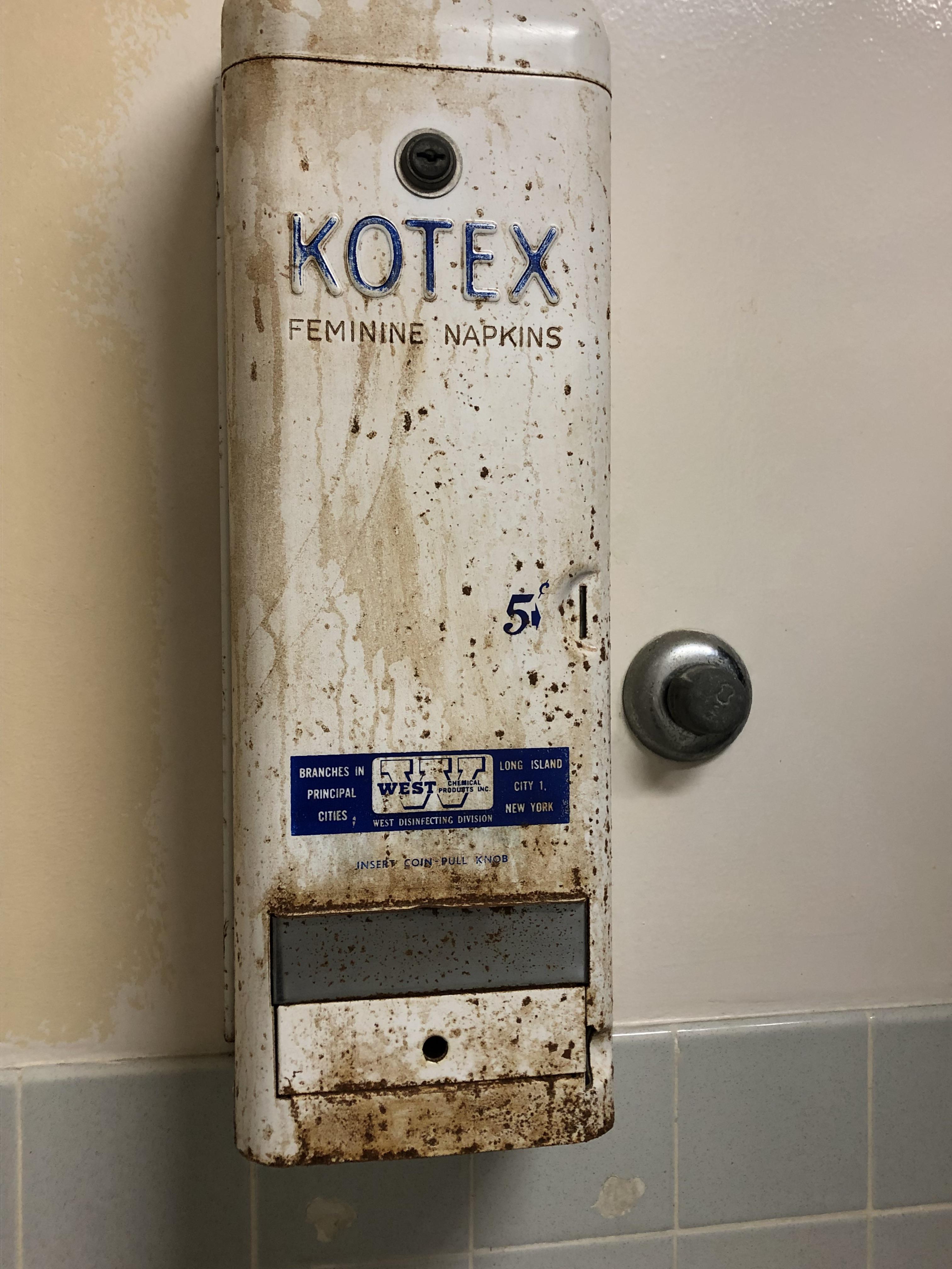 This extremely old tampon(?) dispenser in the bathroom at my school r