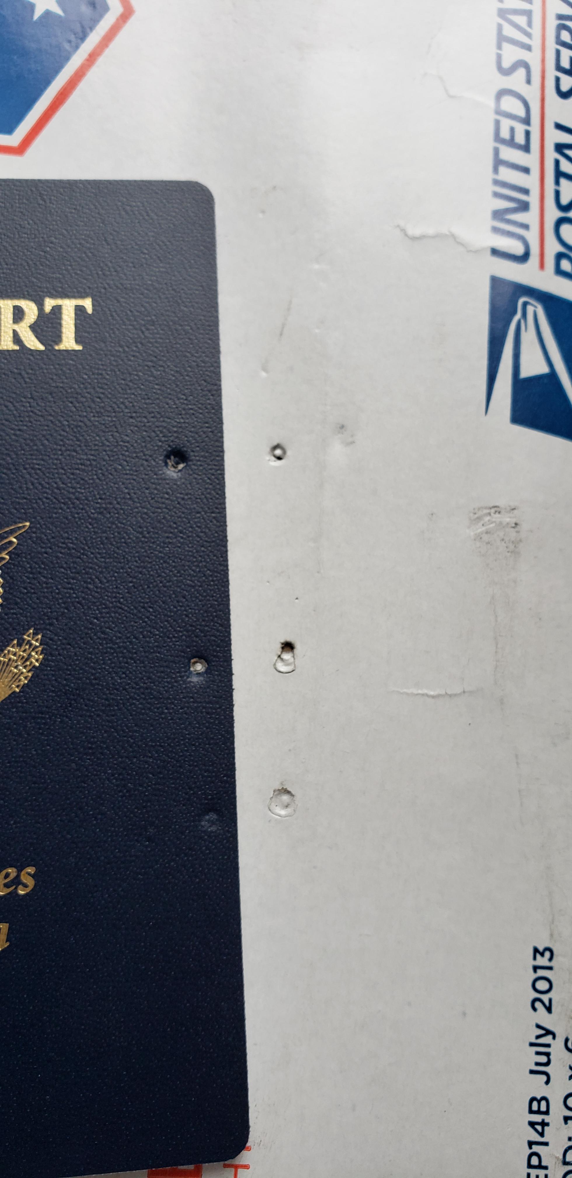 USPS damaged my new passport. Looks like they punctured it with some