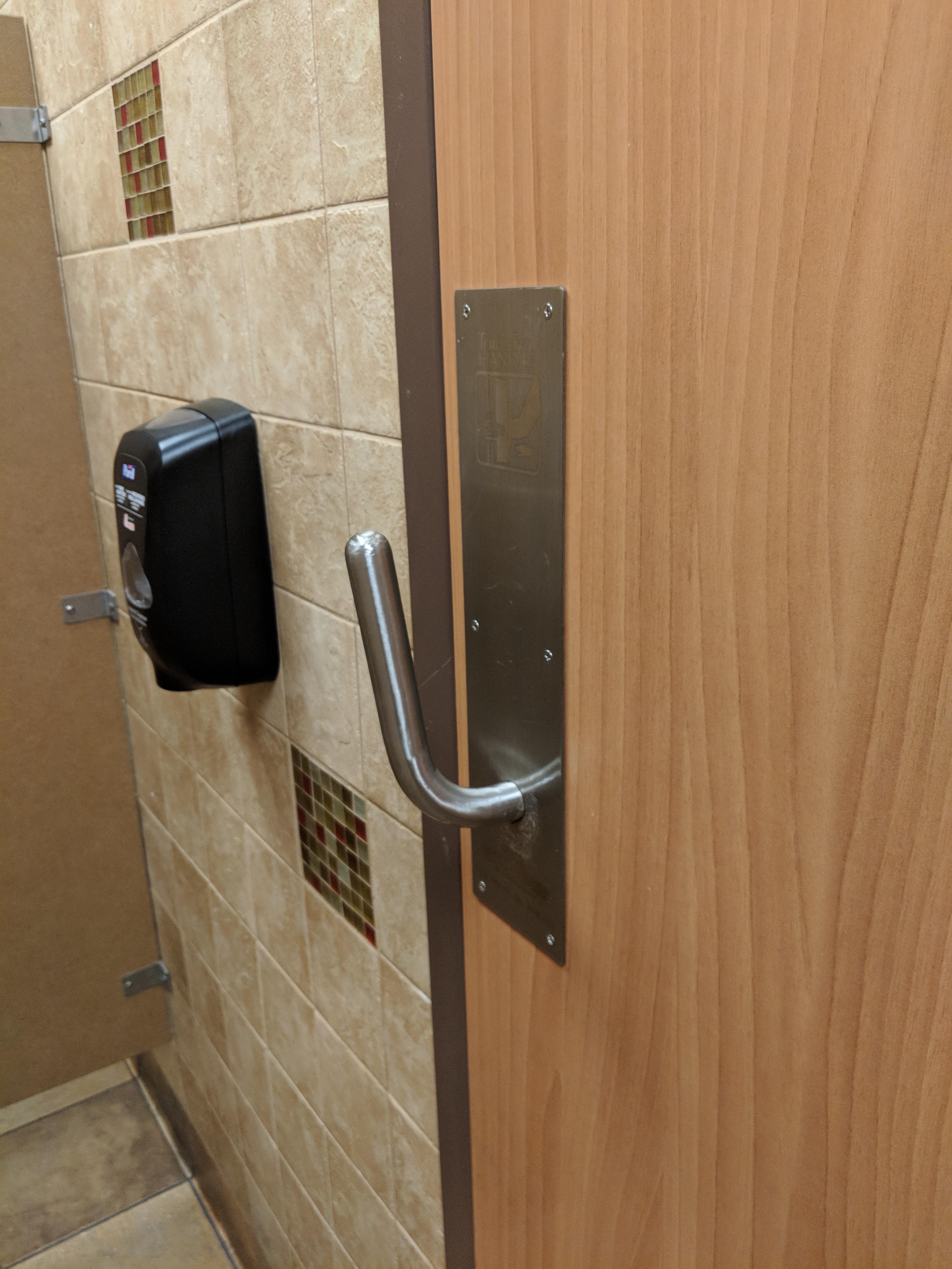 This bathroom door handle lets you pull a door open with your arm