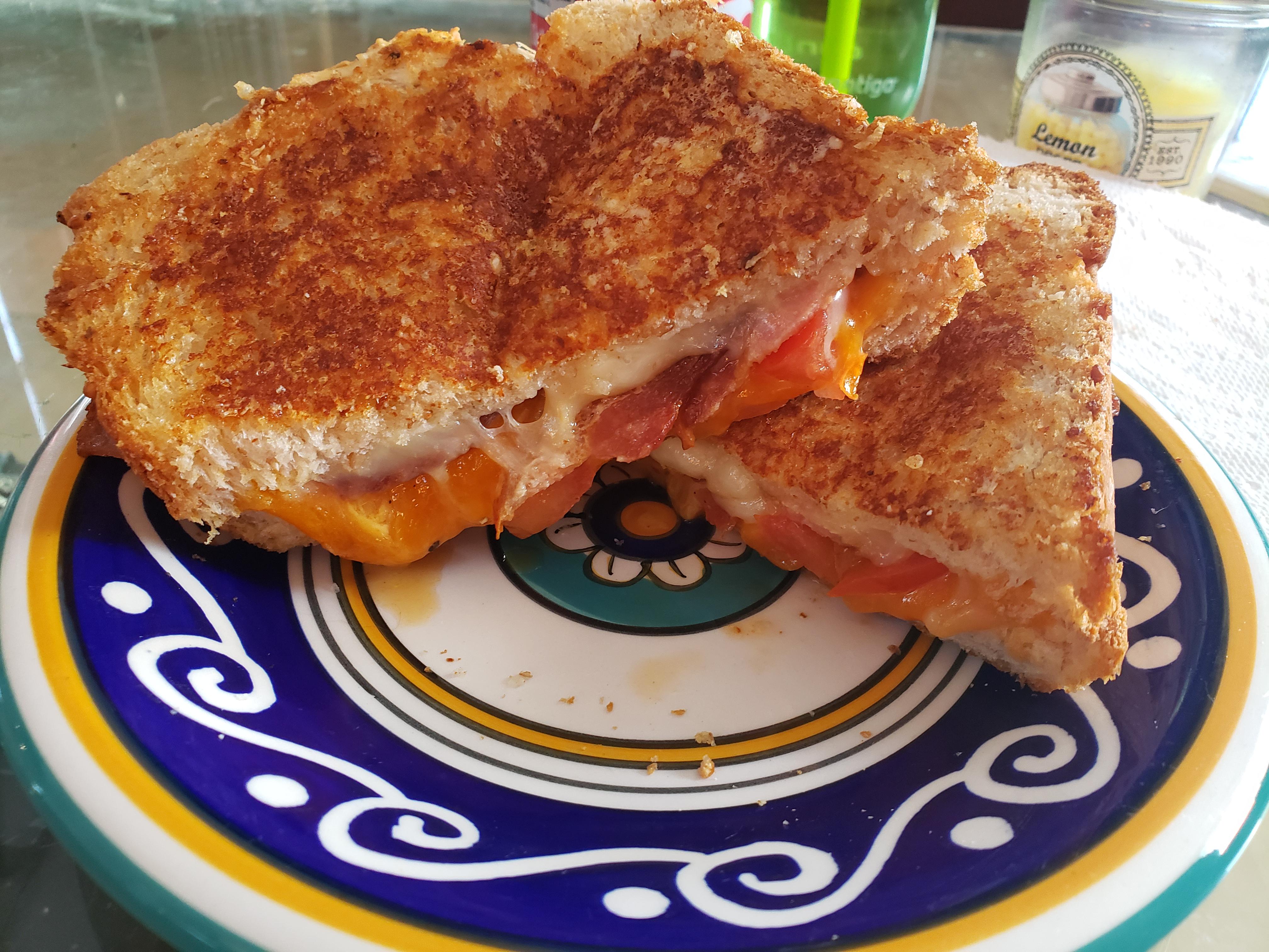 Aged Cheddar, habanero Monterey jack, tomato and bacon, on a parmesan