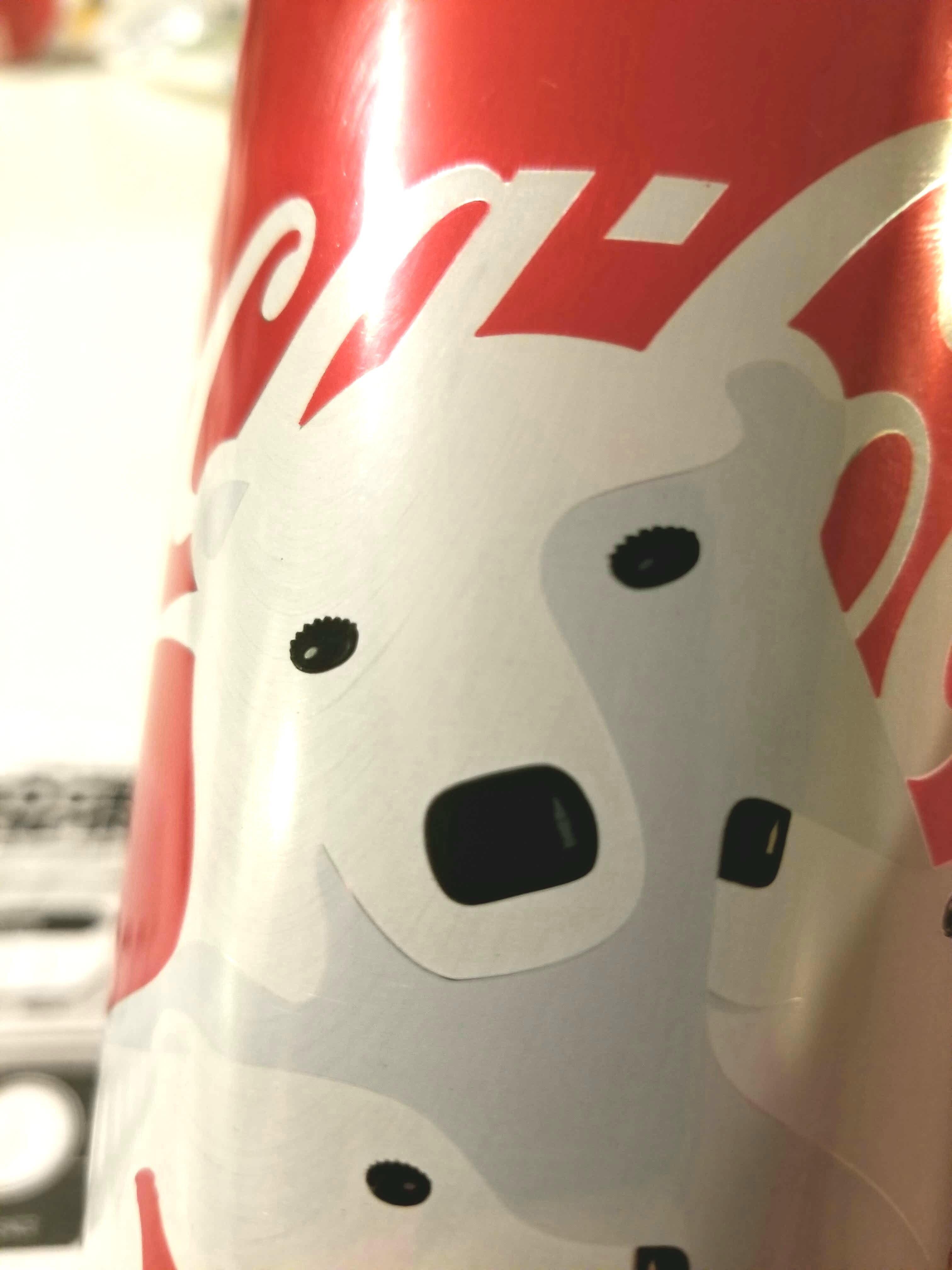 The eyes are bottle caps and the shine on the nose is a bottle. (x