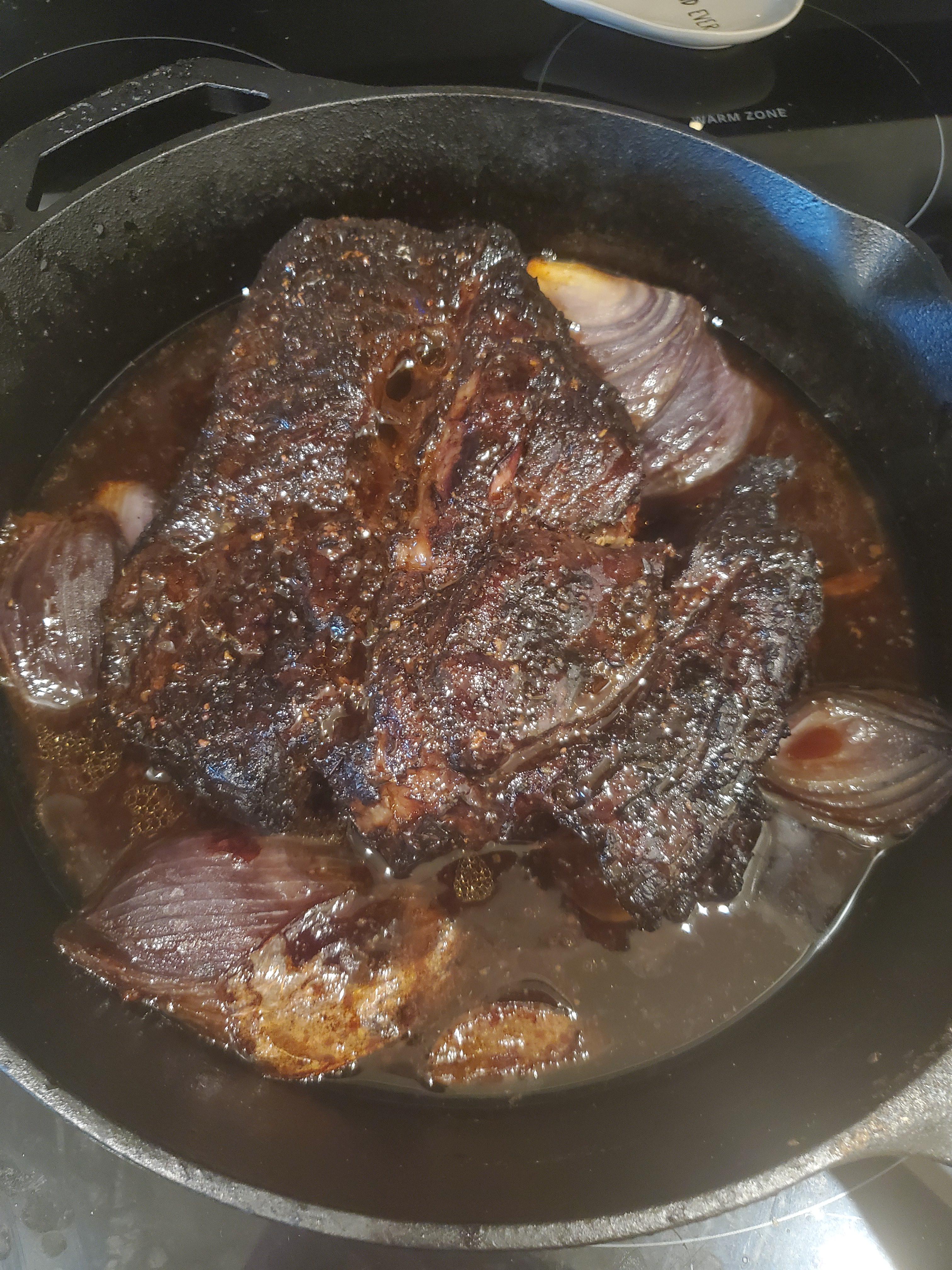 Chuck roast on WSM. Smoked for 5 hours with cherry chunks then put in the cast iron with beef