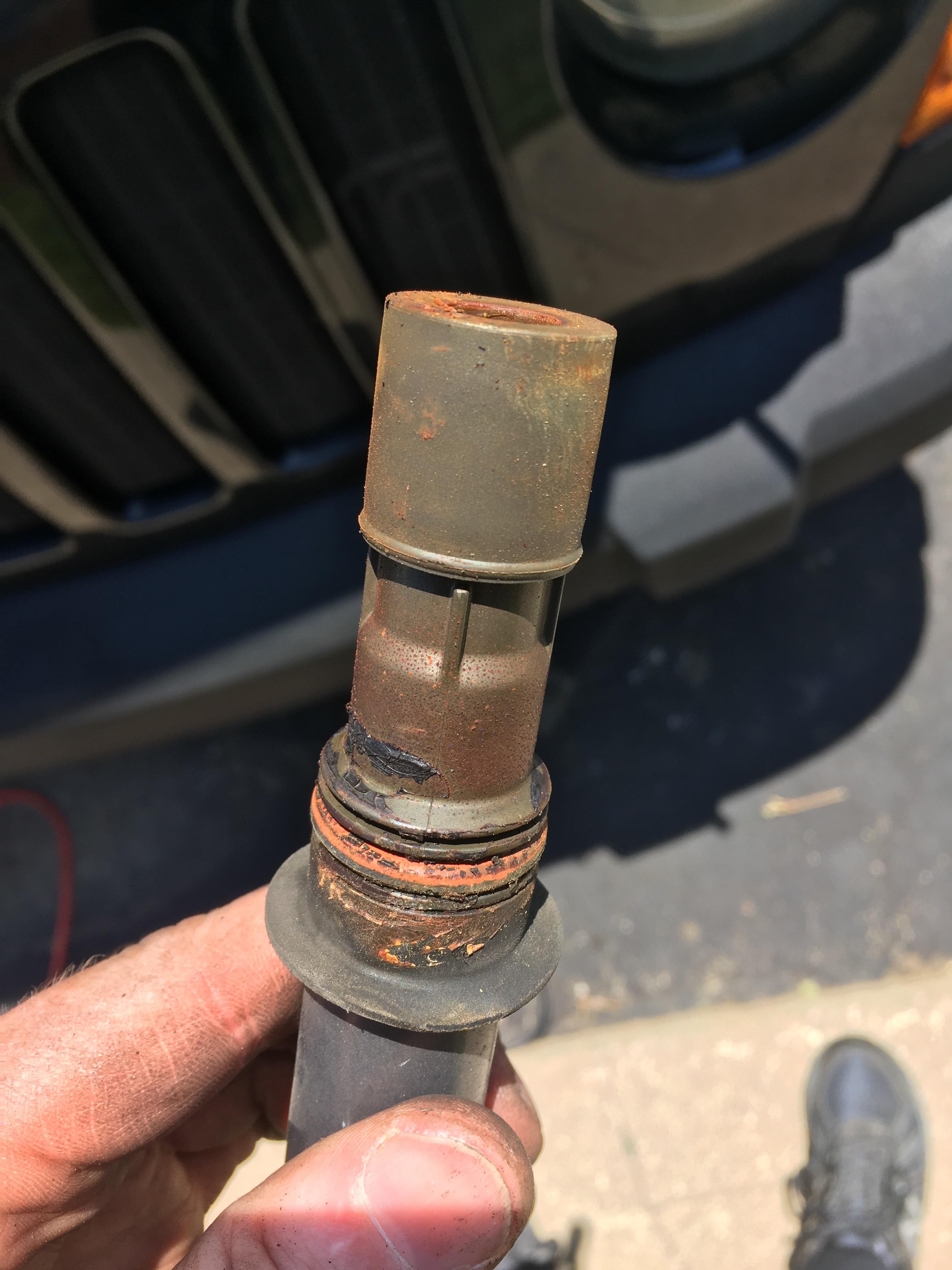 05 Jeep Liberty. Cyl 6 Ignition Coil. Is that oil? What would cause