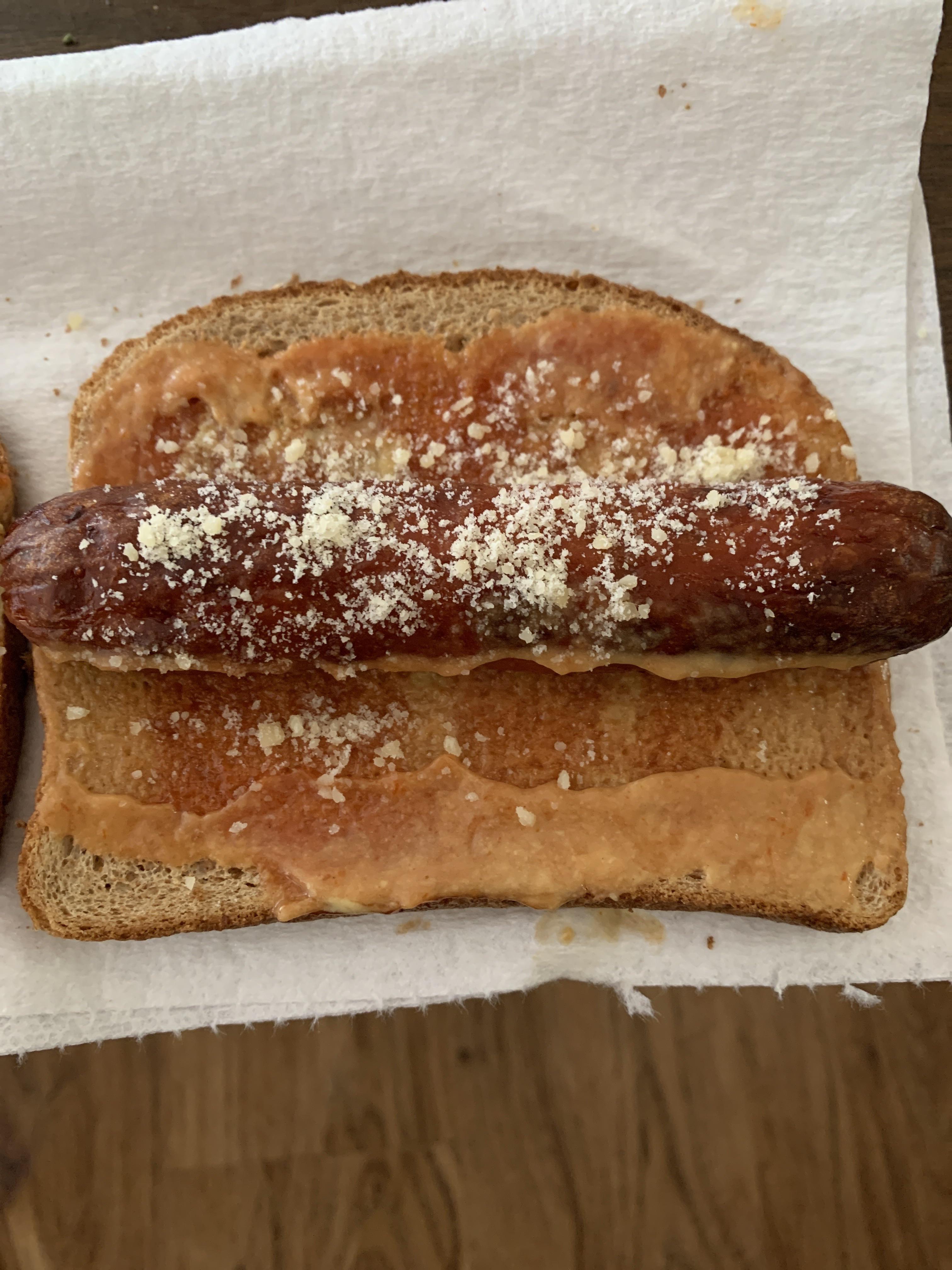 Cheddar cheese dog on toasted whole grain, with a ketchup/Dijon spread