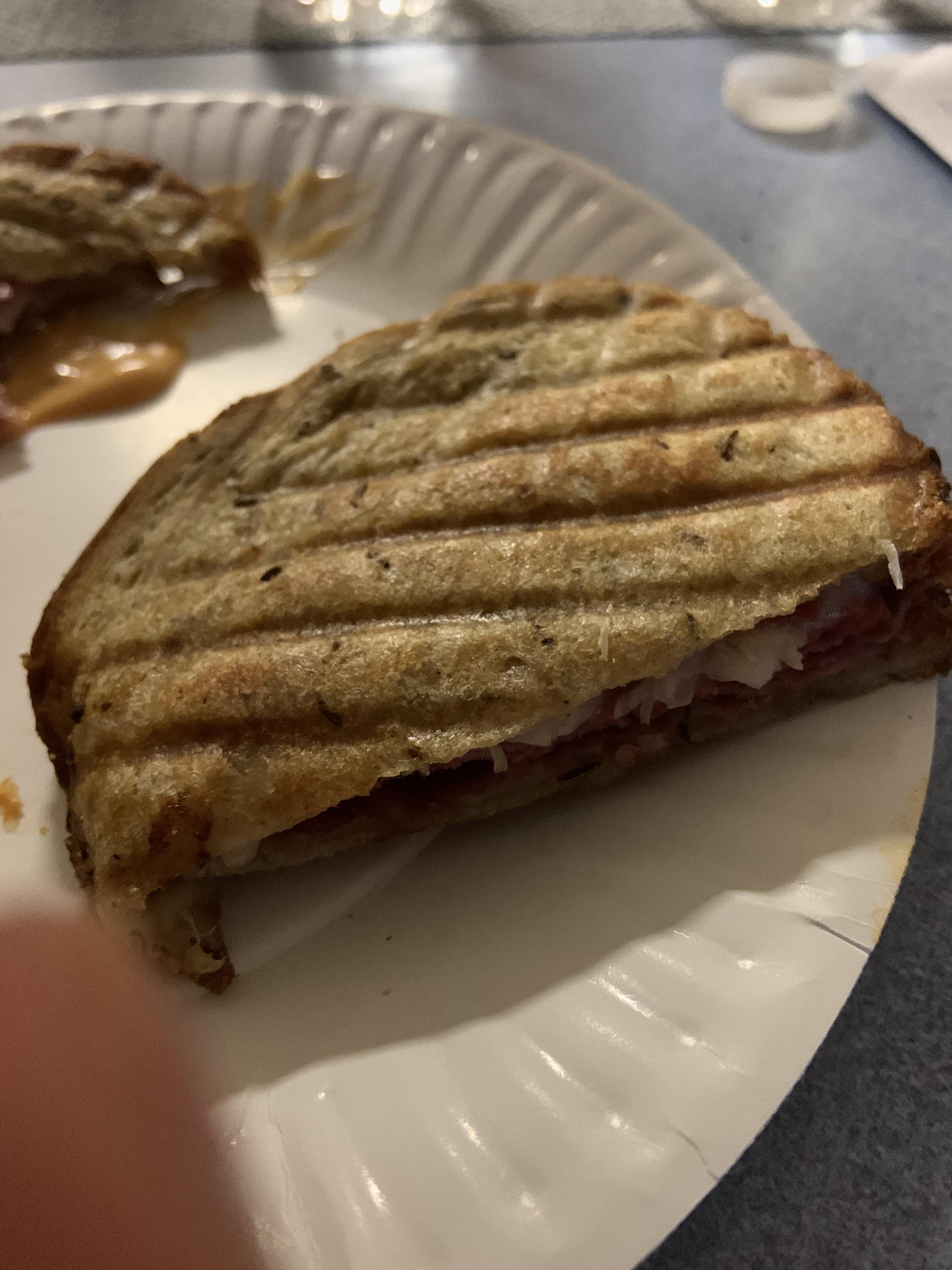Reuben sandwich(sauerkraut, pastrami, and some cheese on rye bread) r