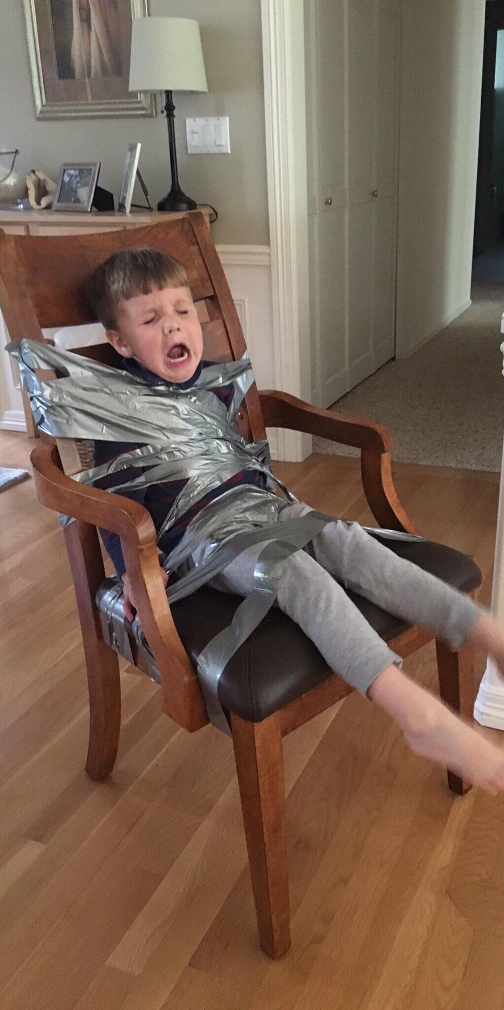 PsBattle Kid ducttaped to a chair