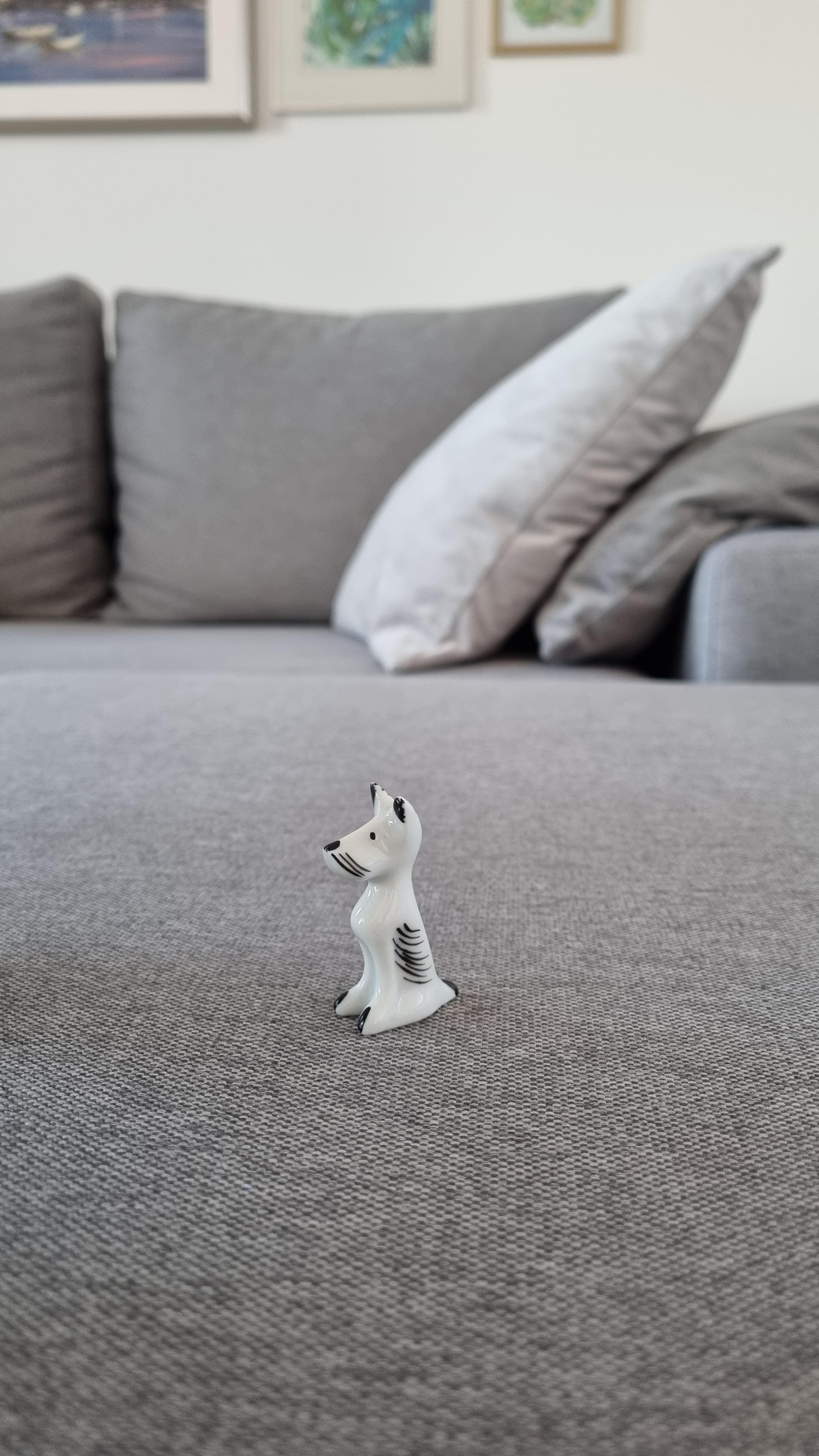 Please help with info, 4cm(2.5in) dog porcelain figurine. No markings, approx '60'70, Europe
