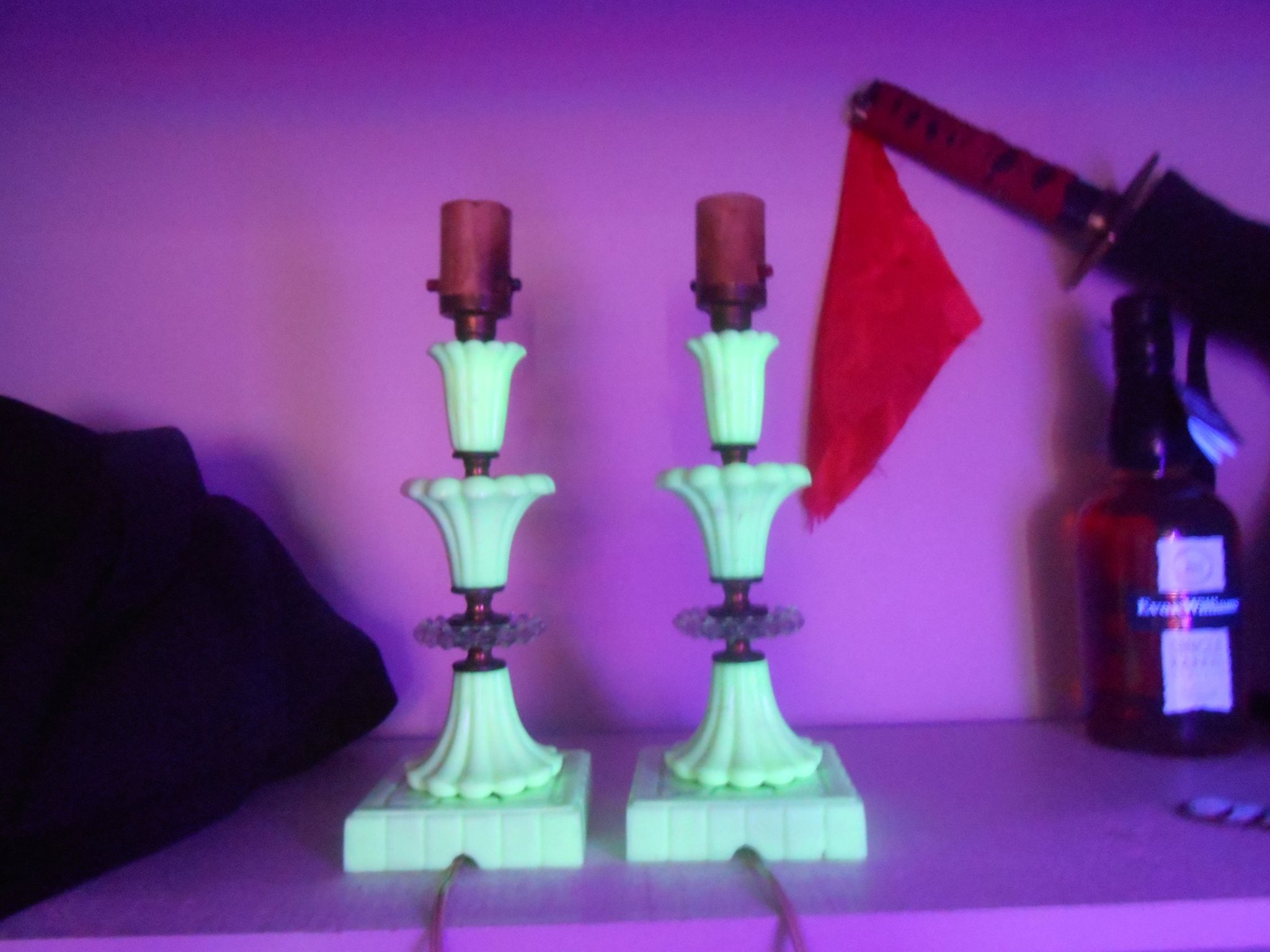 These two vintage off white glass lamps glow under a blacklight because