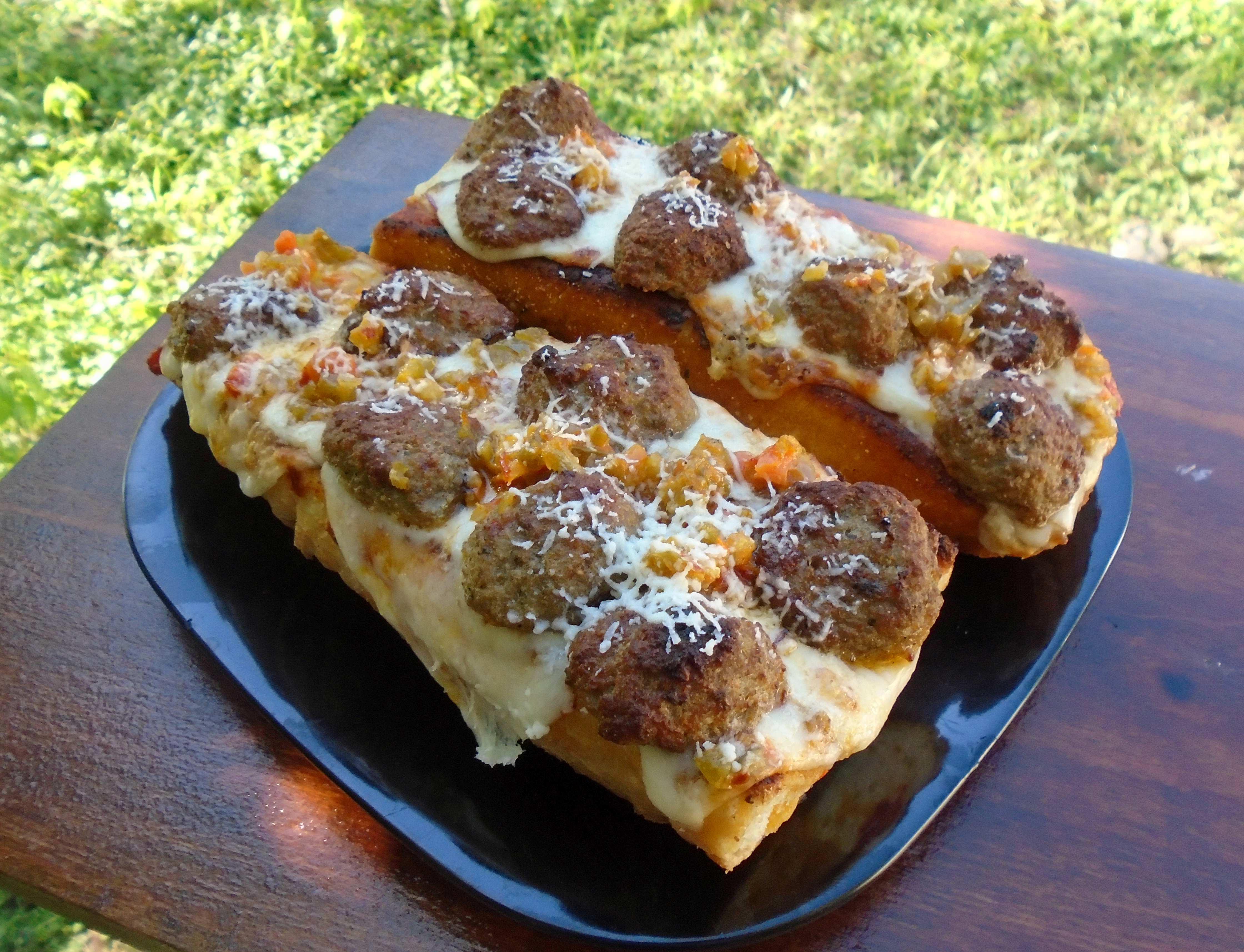 Open faced meatball sub on toasted garlic bread + marinara, giardiniera